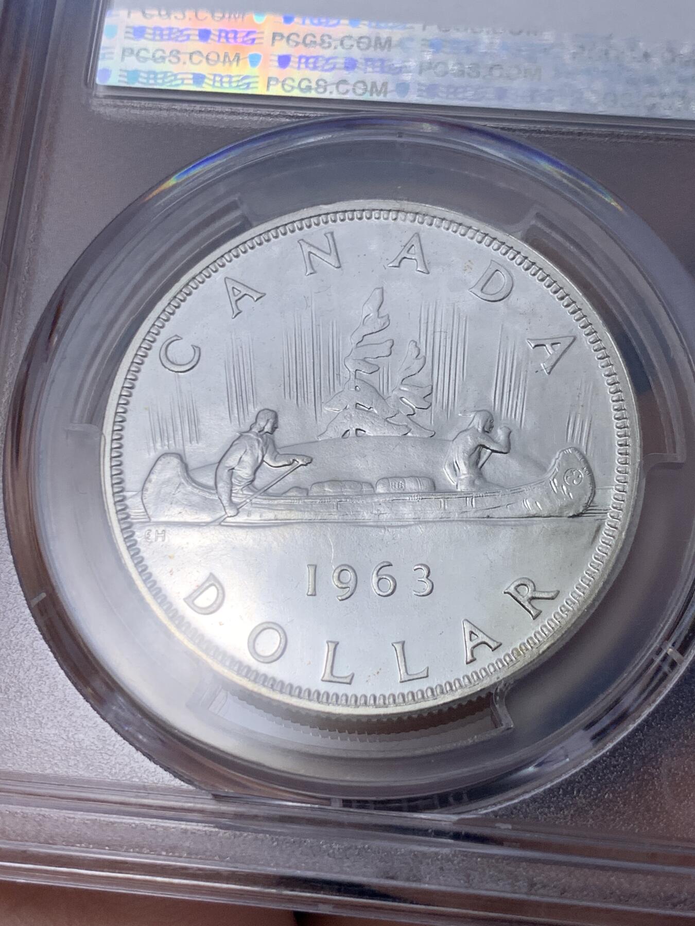 《竞宝斋》第296场- 周日，周一  2场连拍 （全场包邮） PCGS PL66 加拿大1963年独木舟划船1元银币 币面清爽干净又漂亮，类镜面效果，伊丽莎白二世青年头像，经典原住民划船图案，图案精美。