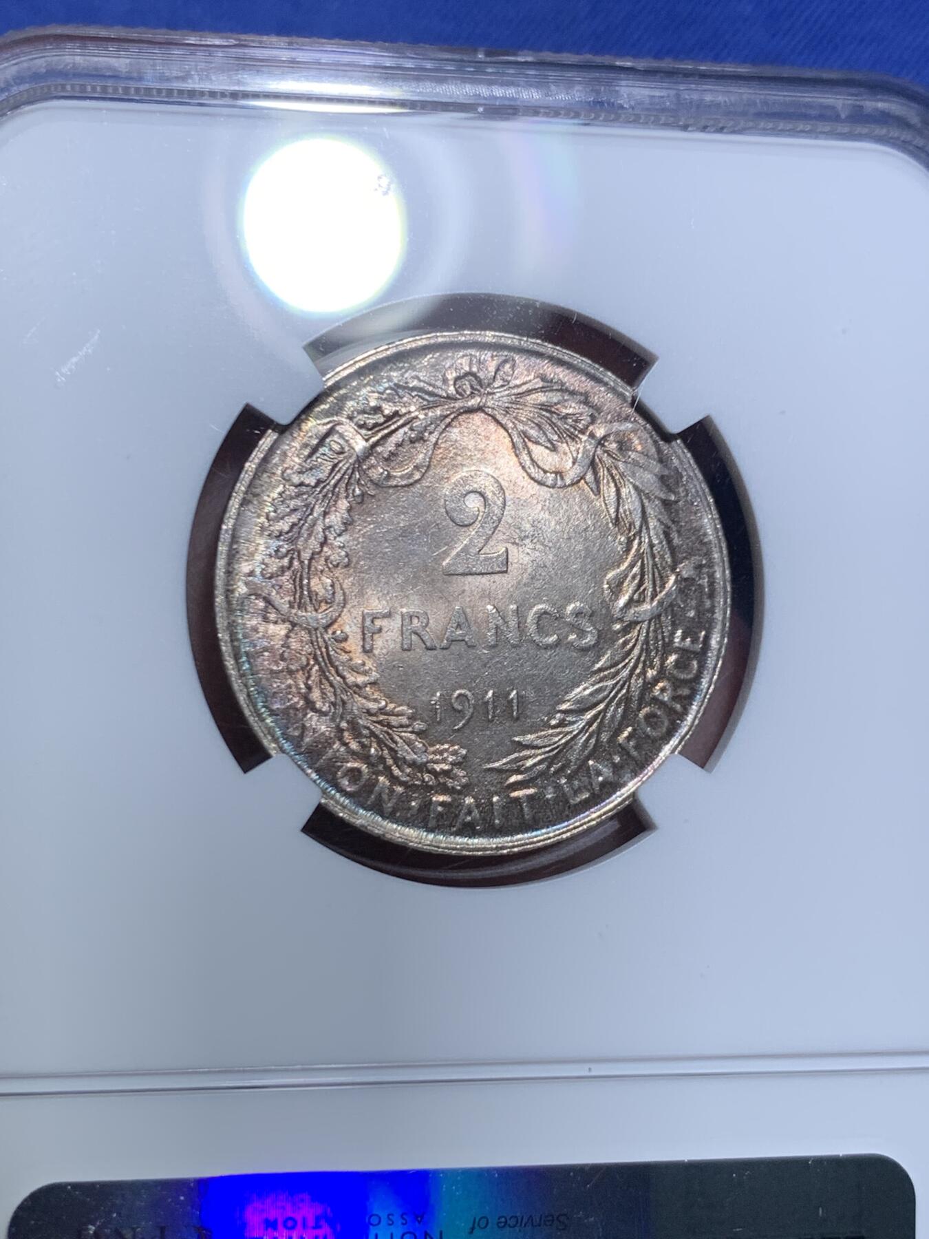 《竞宝斋》第297场- 周日，周一  2场连拍 （全场包邮） NGC MS63 比利时1911年 埃尔佩托 流通2法郎银币，绚丽环彩包浆，顶级状态。只发行了2年的品种，流通充分，更高分仅有4枚