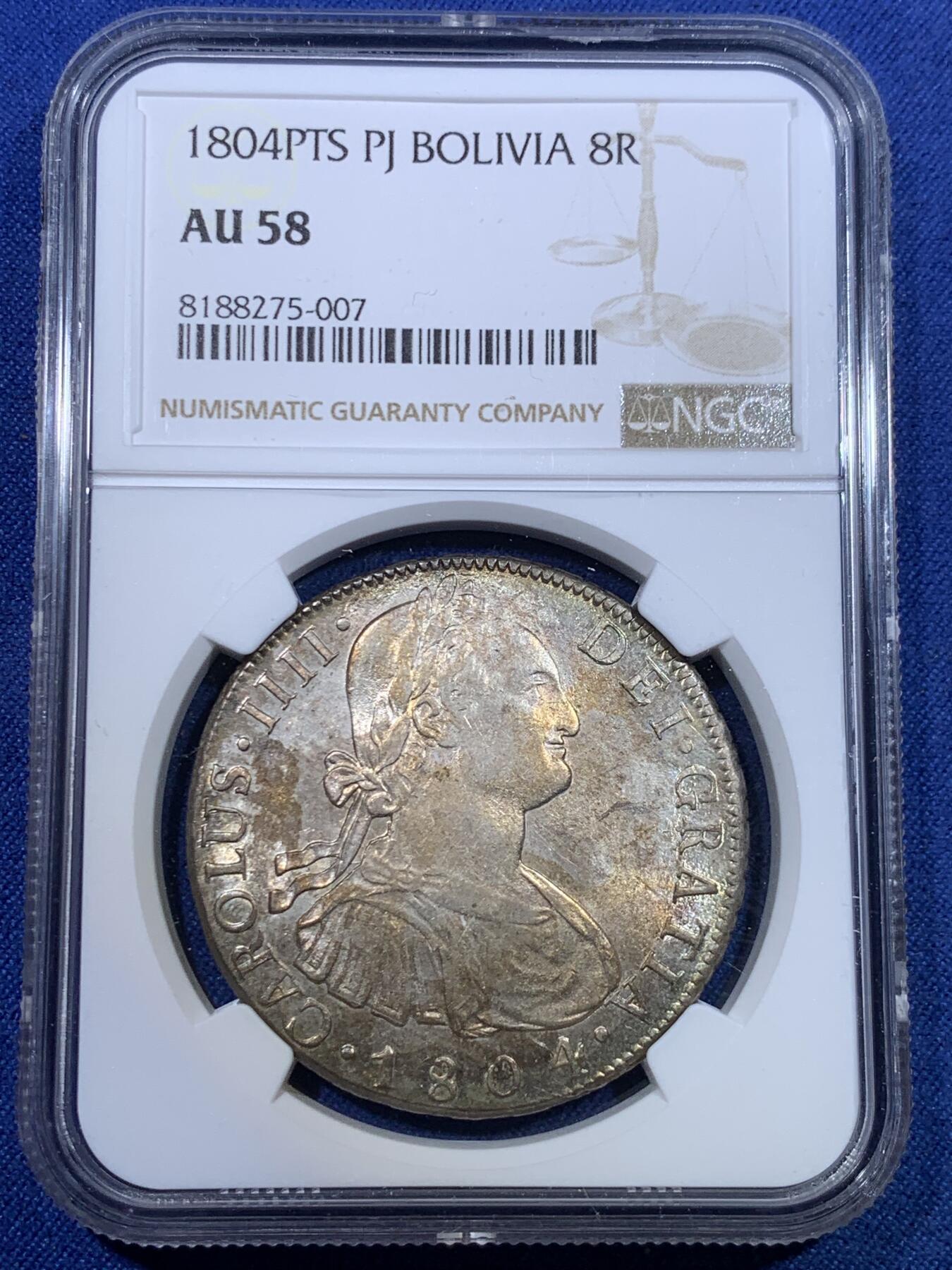 《竞宝斋》第298场- 周日，周一  2场连拍 （全场包邮） NGC AU58 玻利维亚1804年卡洛斯四世8里亚尔银币 高点细节具在，底板几近无痕 光感强烈 币面环状五彩黄油光包浆 非常漂亮，严重低评的一枚