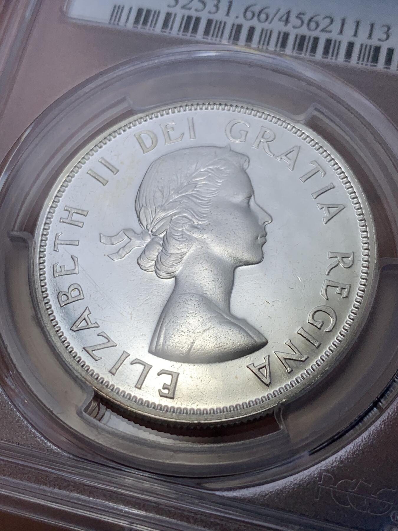 《竞宝斋》第299场- 周日，周一  2场连拍 （全场包邮） PCGS PL66 加拿大1962年独木舟划船1元银币 币面清爽干净又漂亮，类镜面效果，伊丽莎白二世青年头像，经典原住民划船图案，图案精美。