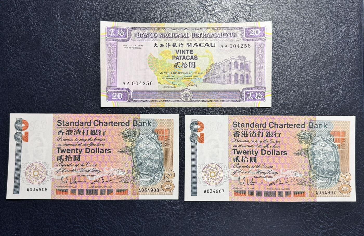 收藏联盟Quantum Auction 第372期拍卖  澳门大西洋银行1996年20元AA冠千位号和香港渣打银行1985年20元AA冠 品相为UNC-  边缘轻微荧光点