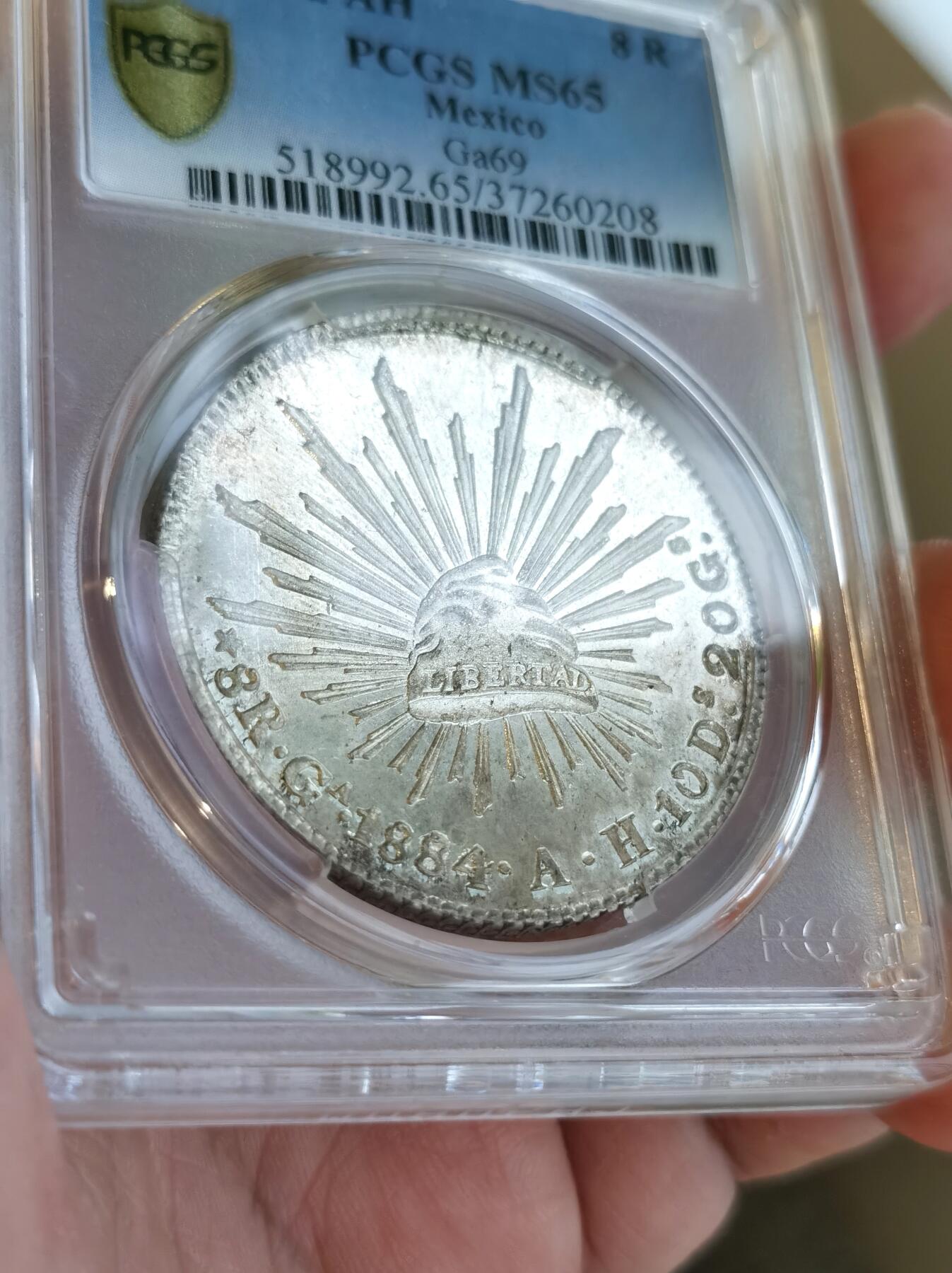 博洋堂世界钱币拍卖第092期（全场包邮） PCGS MS65 墨西哥1884年GA AH版花边鹰洋，少见Ga厂顶级高分，全深打有点初铸状态，底板带镜面感，收藏一步到位！