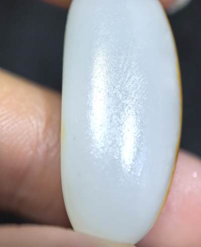 和田籽料撒金皮羊脂白玉吊坠挂件，玉质油润细腻打灯无结构，未打孔可代镶，表皮可见天然毛孔！尺寸:2.9*1.2*0.8cm   克重:5.7g ​ 和田籽料撒金皮羊脂白玉吊坠挂件，玉质油润细腻打灯无结构，未打孔可代镶，表皮可见天然毛孔！尺寸:2.9*1.2*0.8cm   克重:5.7g ​