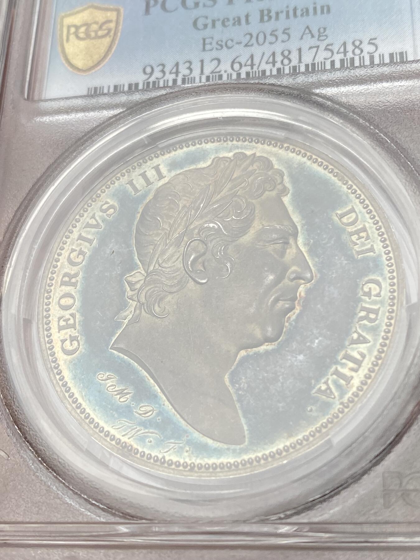 万国钱币拍卖第035期（金银流霞●万国秋季大拍） PCGS PR64DCAM 1820年英国乔治三世克朗样币 乔治三世样币系列中非常稀有的一枚，由Thomas Webb和George Mills两位雕模师联合创作，背面采用了查理二世时期引入的十字盾徽设计，四种徽章围绕着嘉德勋章内的圣乔治屠龙，其中汉诺威战马致敬了乔治三世的日耳曼血统。超高浮雕，深度镜面，均匀的蓝绿色包浆更是锦上添花，原NGC PF65CAM砸盒，PCGS唯一冠军分。