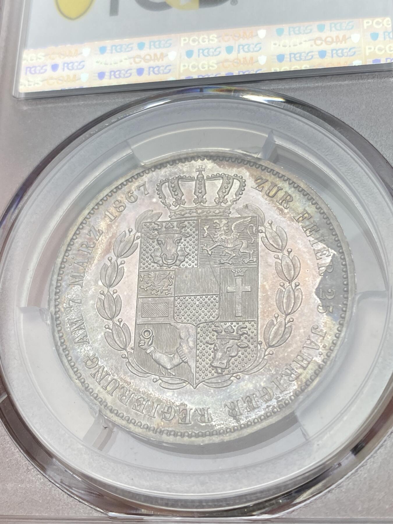 万国钱币拍卖第035期（金银流霞●万国秋季大拍） PCGS MS64 1867年德国梅克伦堡-什未林盾徽流通1泰勒 盾徽非常华丽的小邦泰勒 渐变式七彩环绕  镜面感极强 顶级收藏品质