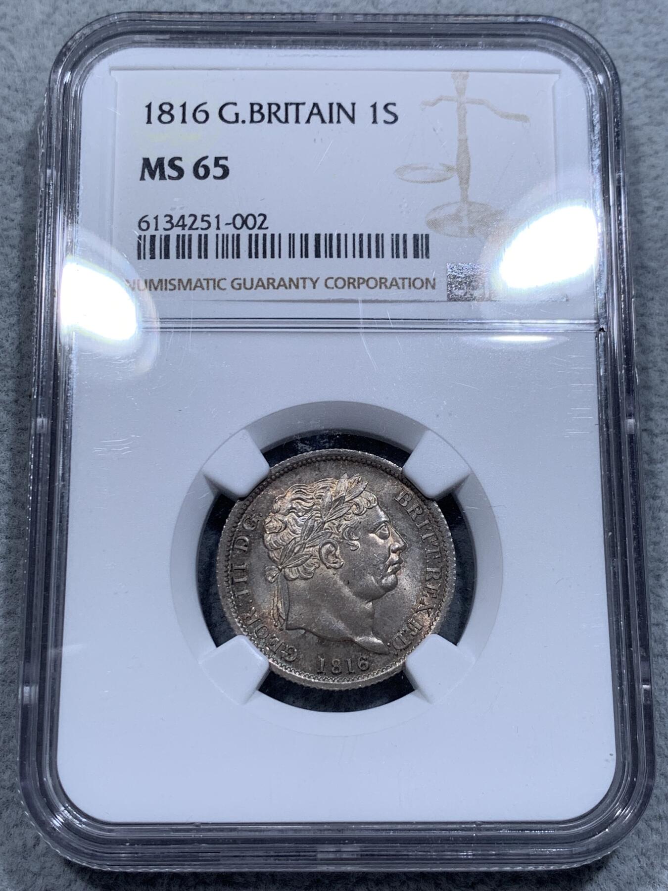 《竞宝斋》第315场 周日，周一，周二  3场连拍 （全场包邮） NGC MS65 英国1816年 乔治三世牛头1先令银币。好包浆好状态，来自皮斯特鲁奇的经典设计，分数够玩了，稀奇有2750的落槌价。