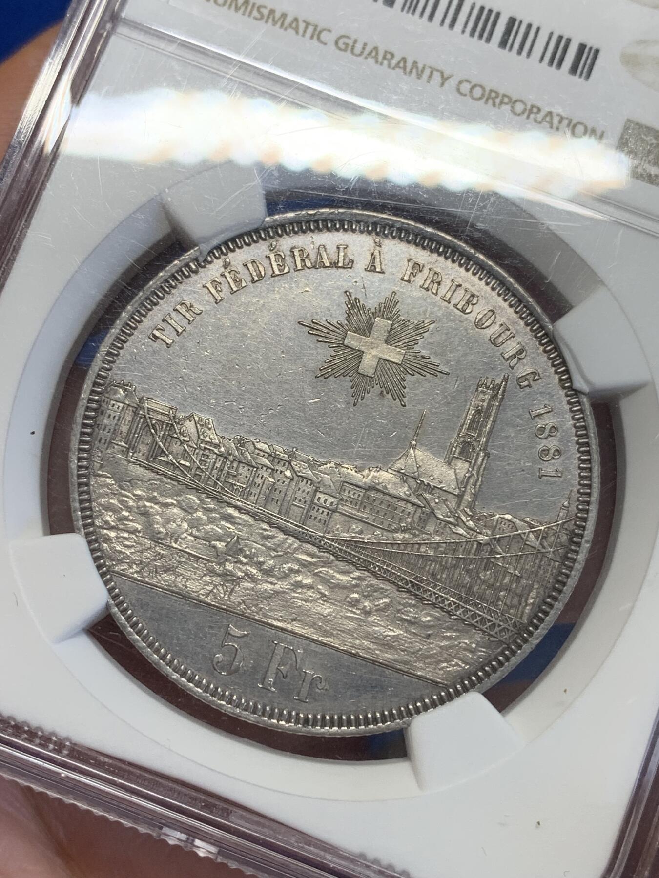 《竞宝斋》第323场 周日，周一，2场连拍 （全场包邮） NGC UNC 瑞士1881 弗里堡射击节5法郎大银币，景观不错，精美的瑞士币种