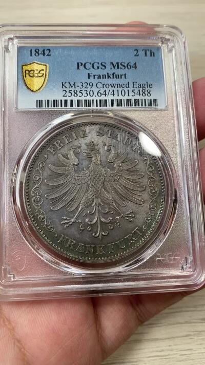 万国钱币拍卖第036期 PCGS MS64 1842法兰克福鹰徽2泰勒 不多见的鹰徽与面值的组合，流通充分品种，难度要比同分少女2泰勒大的多，华丽七彩转光，高分2t价格持续走高，PCGS唯一亚军分，更高分仅一枚。