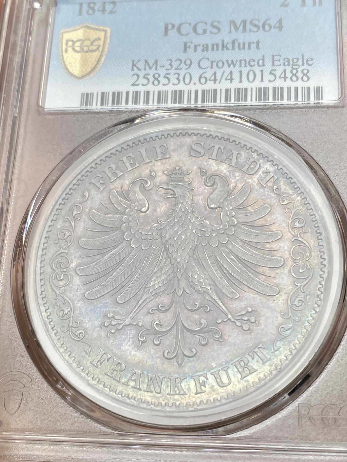 万国钱币拍卖第036期 PCGS MS64 1842法兰克福鹰徽2泰勒 不多见的鹰徽与面值的组合，流通充分品种，难度要比同分少女2泰勒大的多，华丽七彩转光，高分2t价格持续走高，PCGS唯一亚军分，更高分仅一枚。