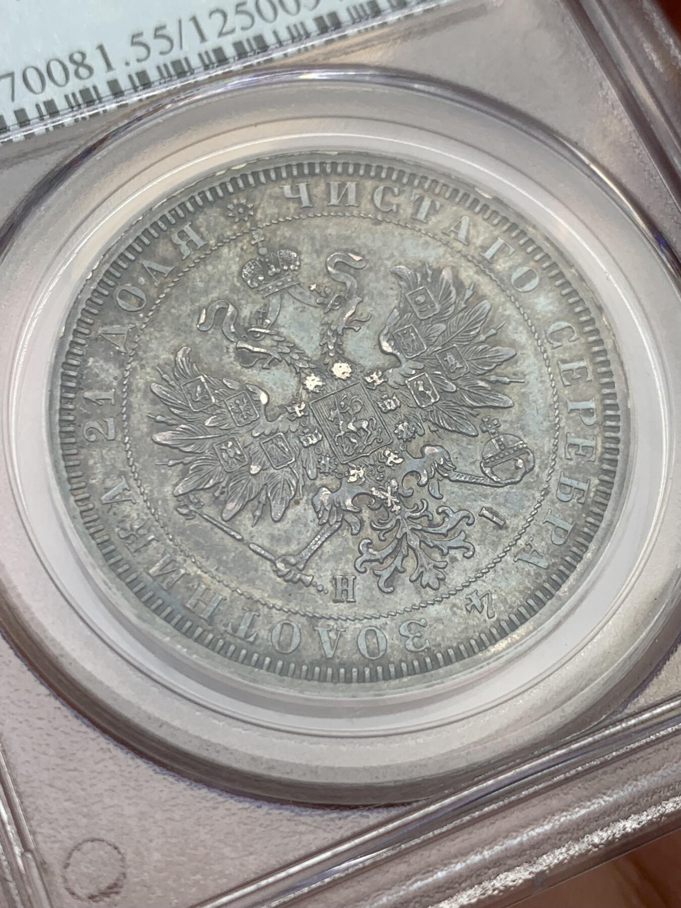 《竞宝斋》第327场 周日，周一，2场连拍 （全场包邮） PCGS AU55 俄国1877年亚历山大二世时期1卢布银币，双头鹰胸前为圣乔治屠龙的盾徽，盾徽被圣安德烈勋章环绕，链章上部两个带X的圆形饰物通常弱打或是磨平，即便MS级能看清的也很少，这枚已经很不错了。