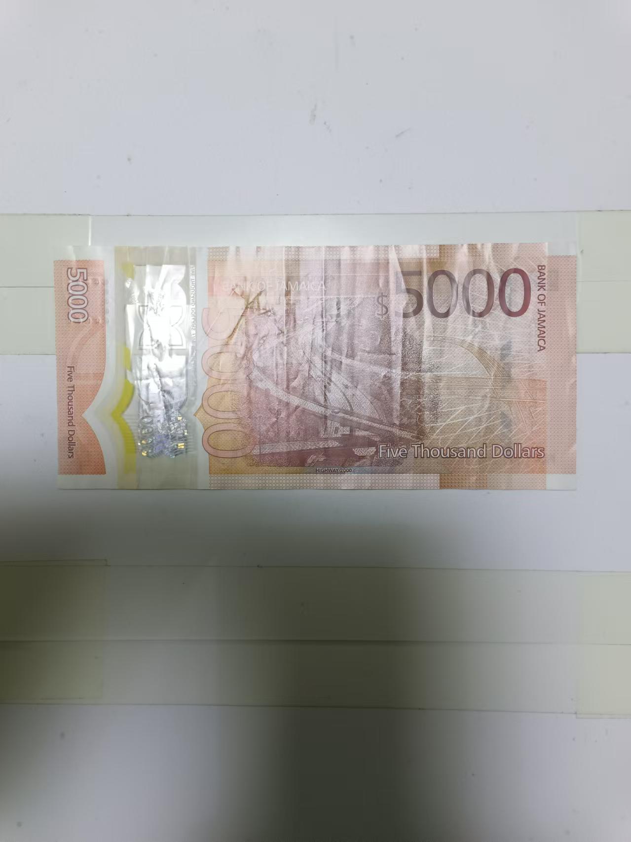 【20241219】非全新纸币第203场 牙买加5000元塑料钞，有裂缝，市场价全新555元左右