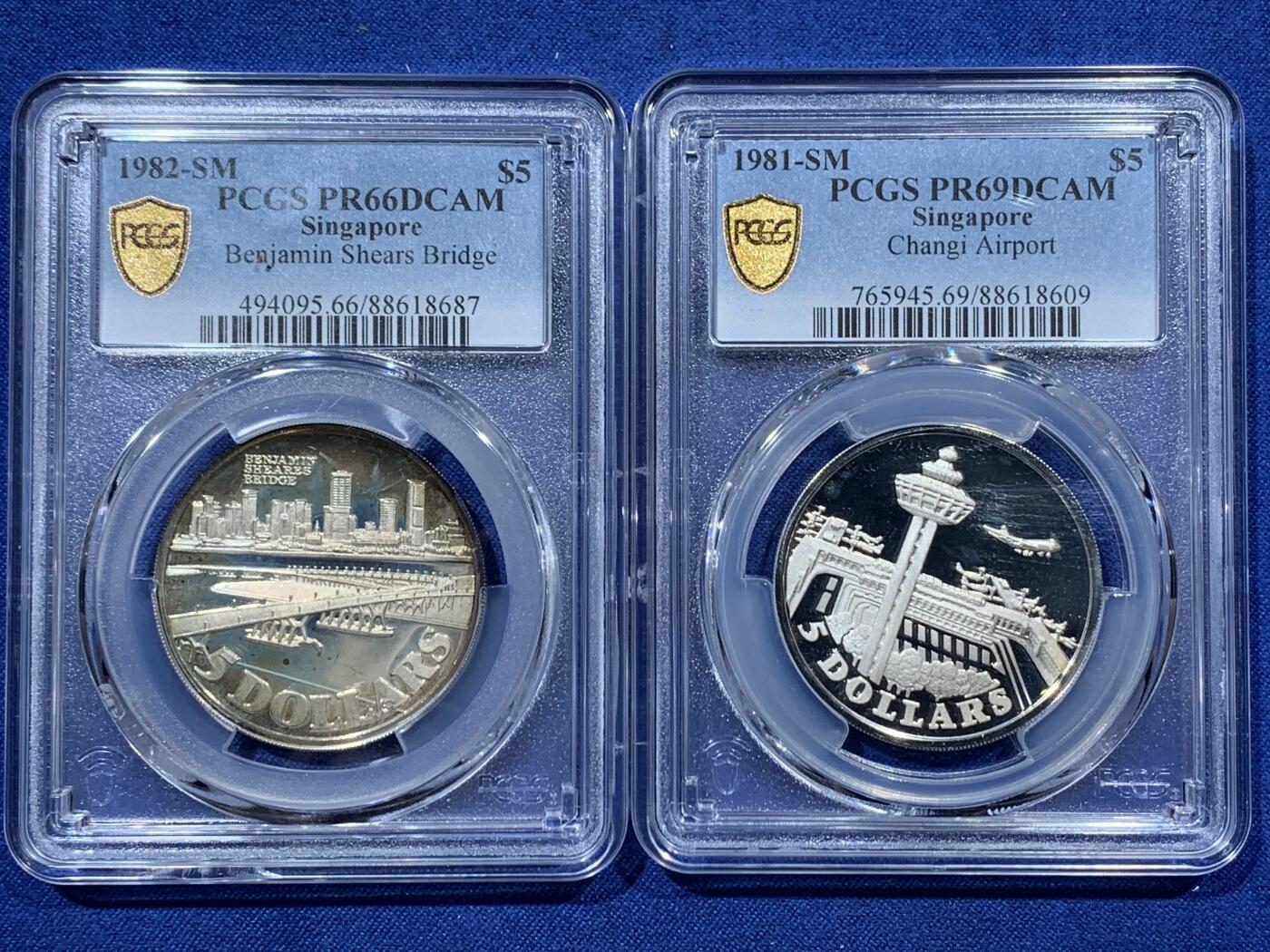 《竞宝斋》第341场 周日，周一，2场连拍 （全场包邮） 两枚一组 PCGS PR69DCAM 新加坡1981年樟宜机场5元银币+PR66DCAM 新加坡1982年本杰明·希尔斯大桥5元银币