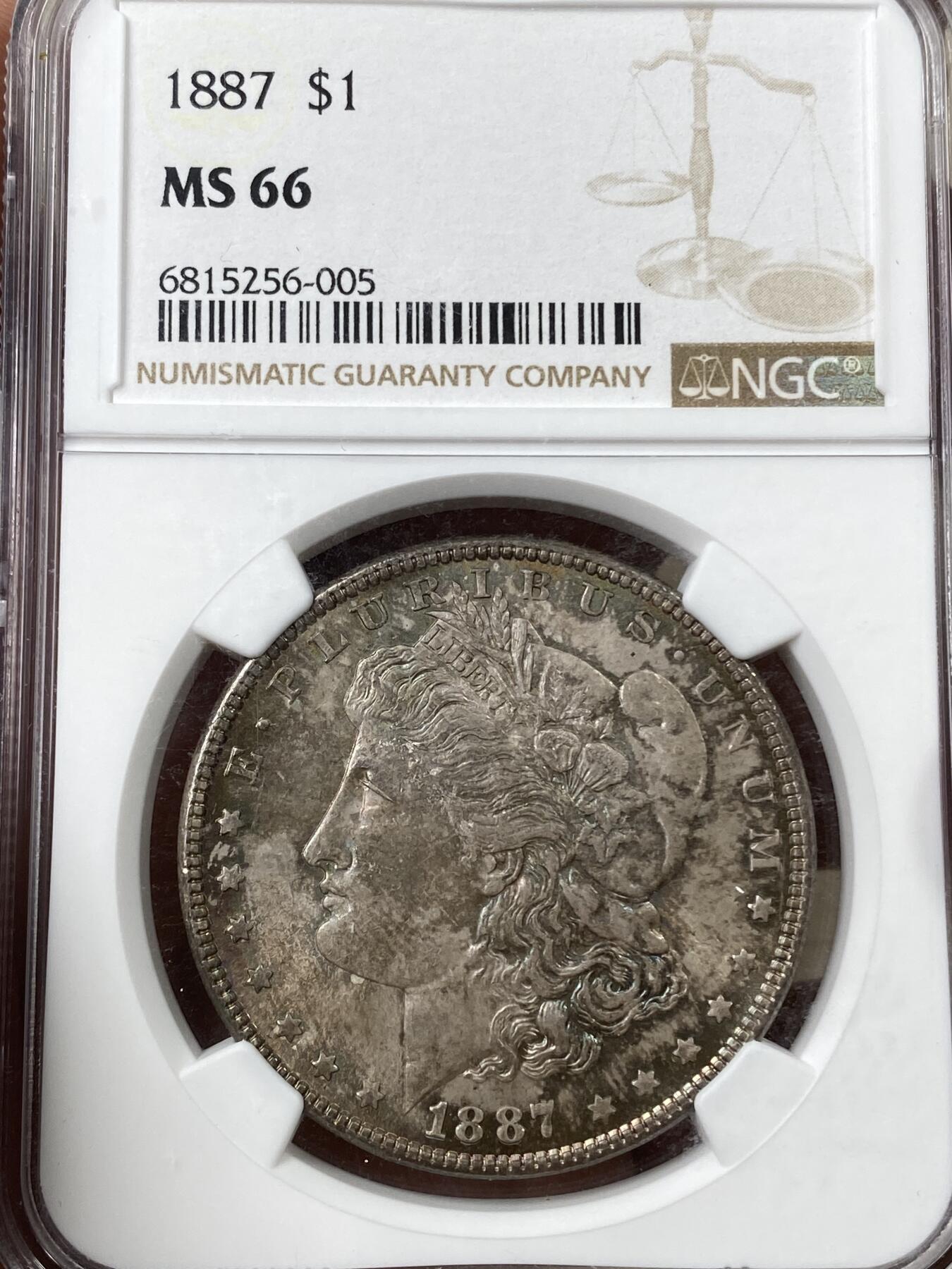 万国钱币拍卖第040期（万国2025新年大拍） NGC MS66 1887年美国摩根女神1元银币 七彩倒影包浆顶级收藏品质