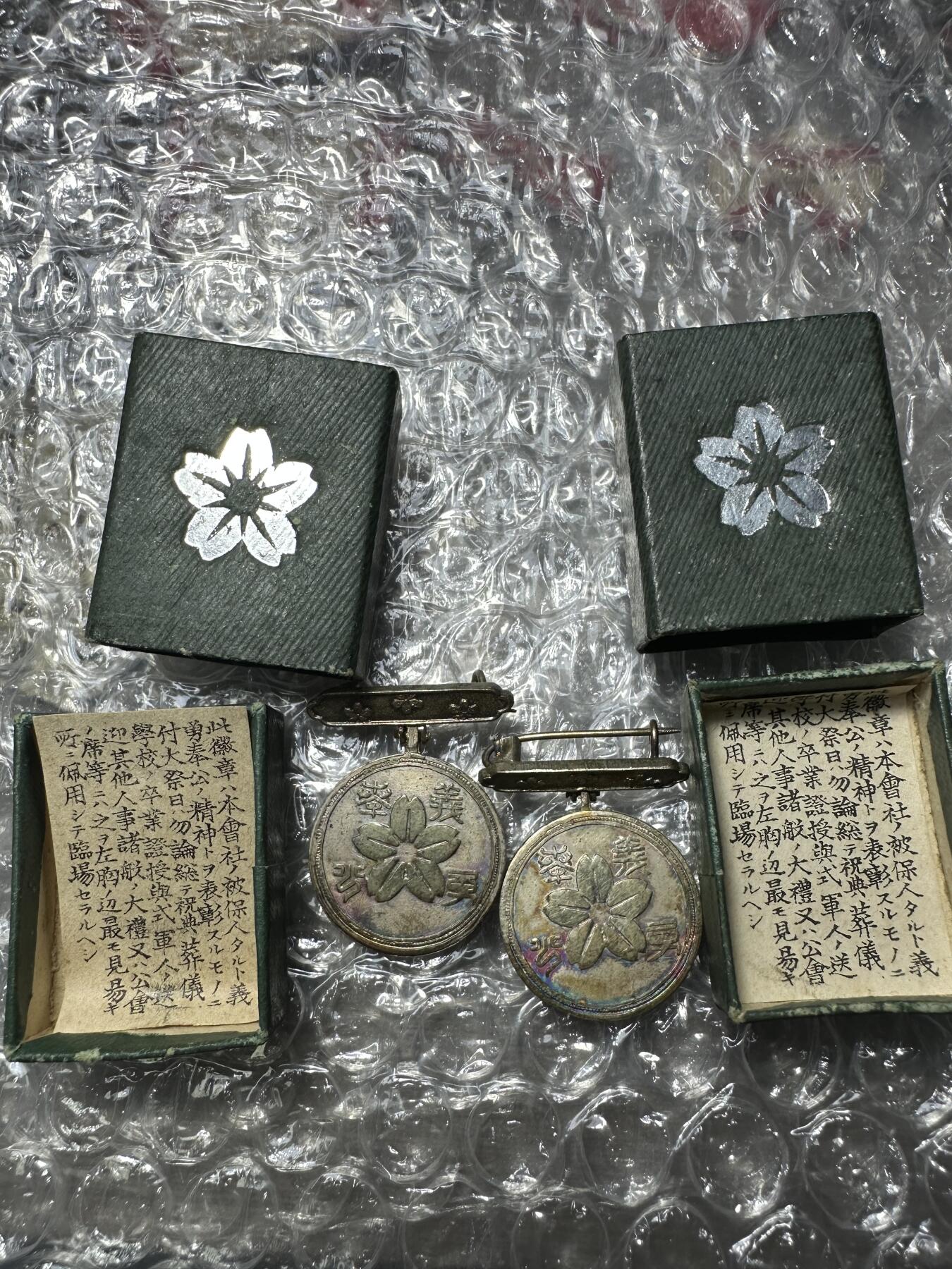 无佣金！章，世界钱币，纸币 罕见明治时代征兵纪念小银章直径22mm单个重约7.2g带原包装还有证书，是研究当时社会政治军事制度的实物资料。正面刻“徵兵保险之章”；背面刻着一朵樱花和“义勇奉公”。该章虽小(钮扣大小)，却包藏着倭国穷兵黩武之大野心