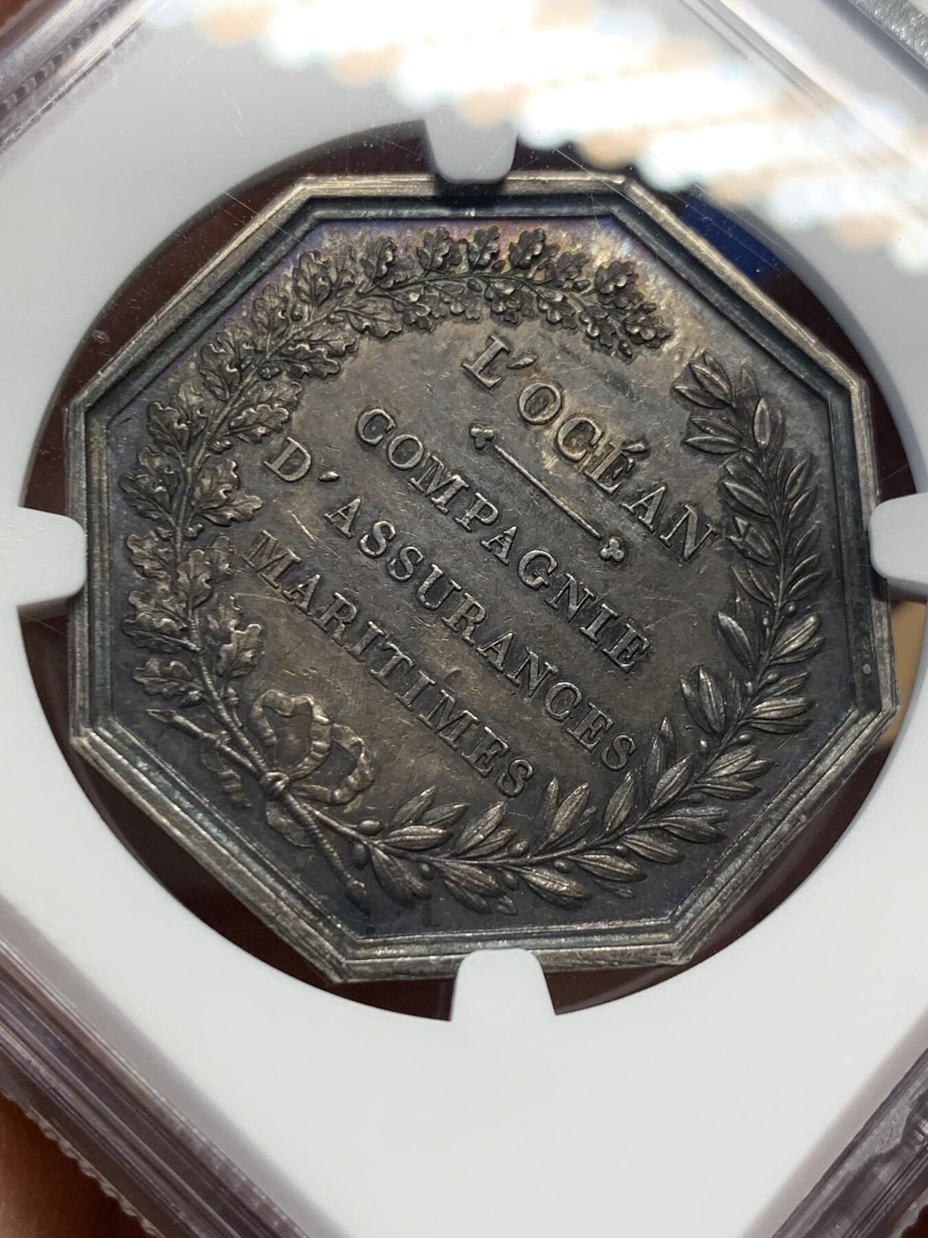 《竞宝斋》第355场 周日，周一，周二 3场连拍 （全场包邮） NGC MS61 法国海王波塞冬八角银质代币，出分不易。正面描绘海神波塞冬，骑在两匹马身上，手持三叉戟。背面有“L'OCEAN COMPAGNIE D'ASSURANCES MARITIMES”字样，以及桂冠装饰。经典藏品，品相极佳，适合收藏
