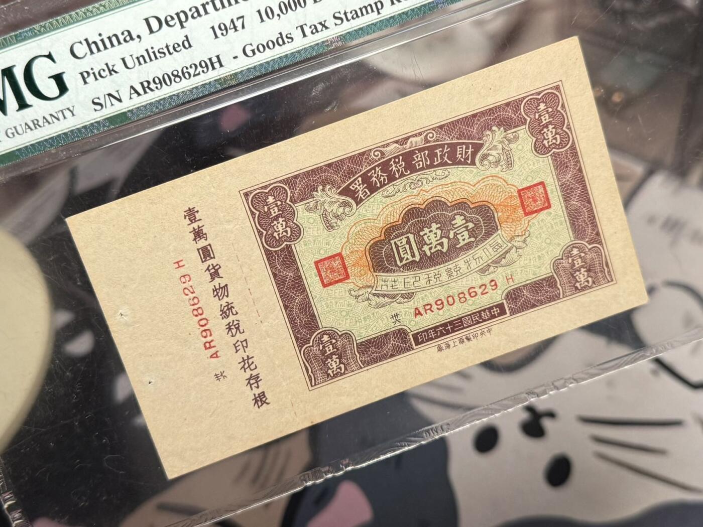 【乾奕收藏】出民国36年1947年财政部税务署货物统税印花壹万圆，号码全程无47，原票带存根，稀少品种，美国PMG64分，民国纸币经过80年能保存如此品相实属难得，喜欢的老板不要错过，评级币一切以分数为准，售出非假不退