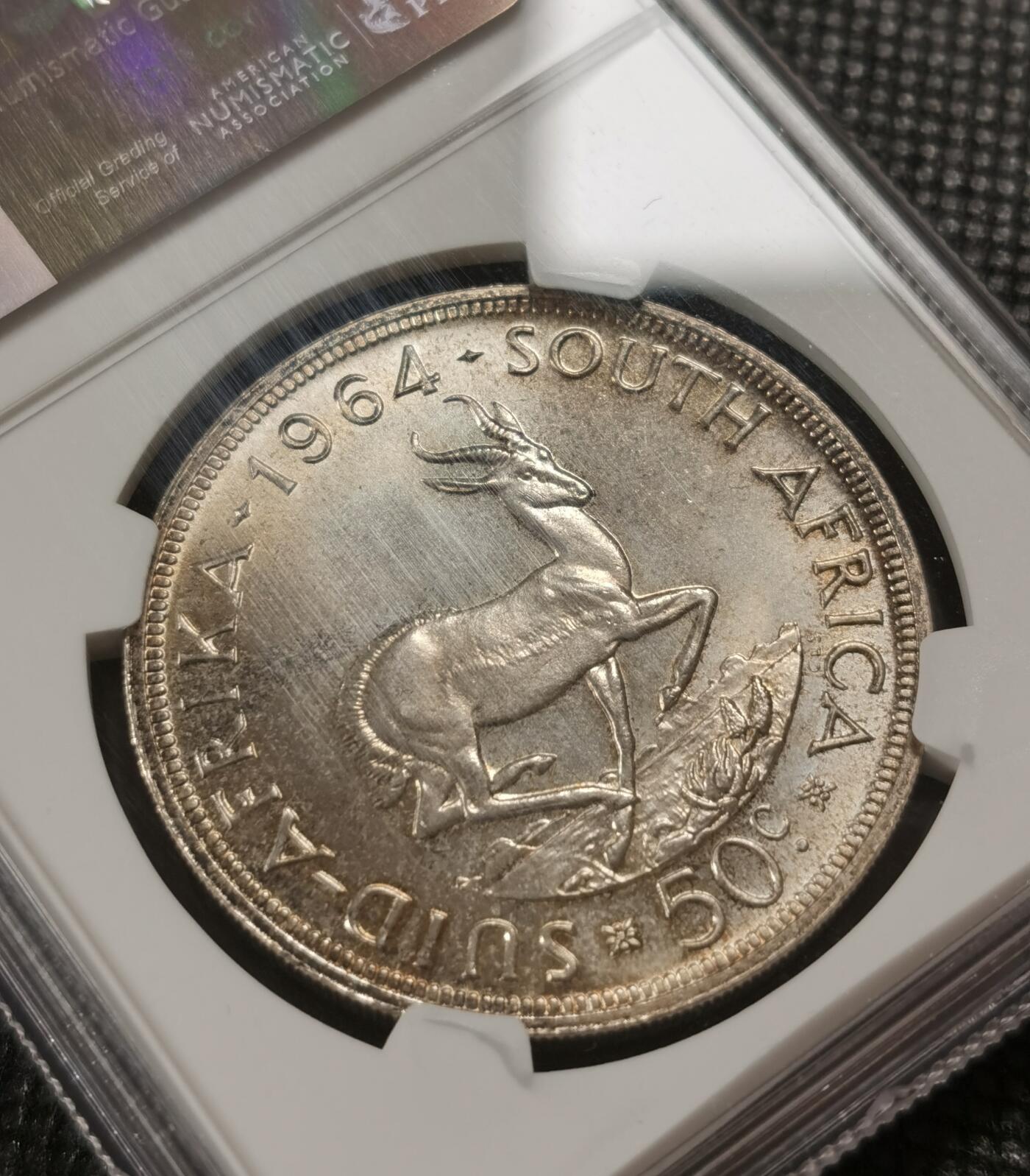 甄臻铺-世界钱币拍卖-南非西非东非专场（第10期）送拍享返佣金等优惠多多 NGC-MS65 南非 1964 50分 吕贝克跳羚银币，原味包浆，币面漂亮