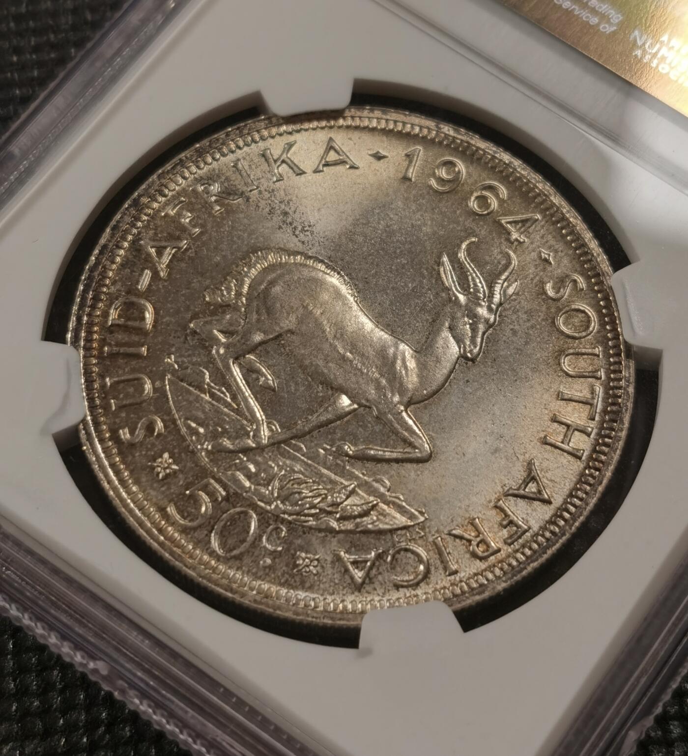 甄臻铺-世界钱币拍卖-南非西非东非专场（第10期）送拍享返佣金等优惠多多 NGC-MS65 南非 1964 50分 吕贝克跳羚银币，原味包浆，币面漂亮