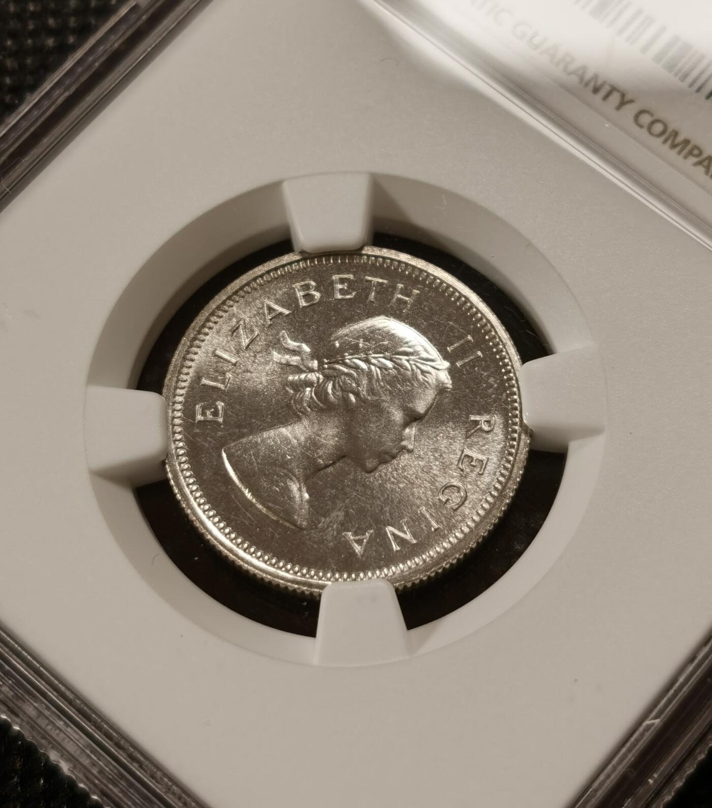 甄臻铺-世界钱币拍卖-南非西非东非专场（第10期）送拍享返佣金等优惠多多 NGC-PF65 英属南非 1953 1先令 银币精制 原味包浆，币面转光