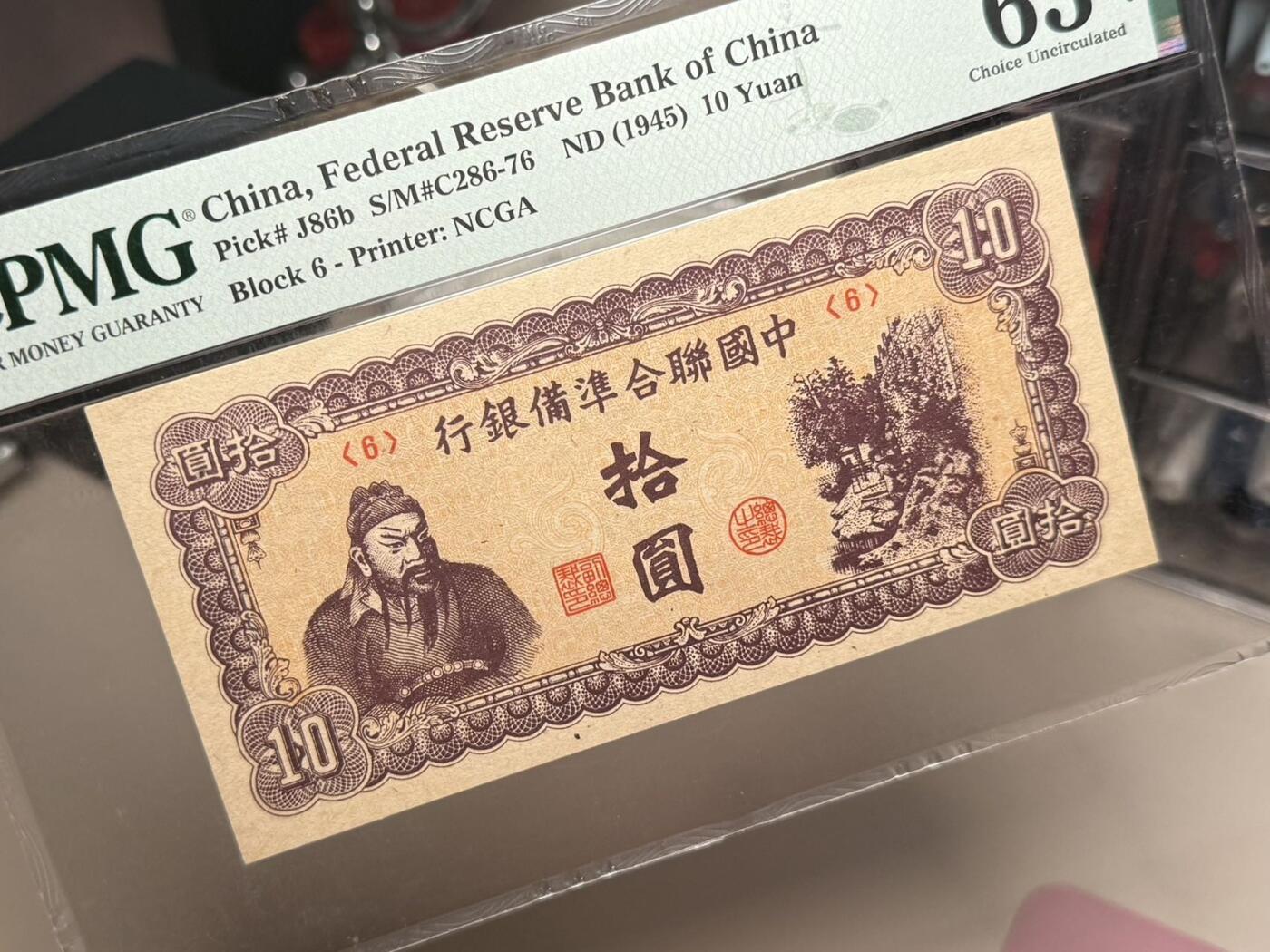 【乾奕收藏】出民国34年1945年中国联合准备银行拾圆，美国PMG63E，紫色关羽像，短号码版，背十四字，华北政务委员会财务厅印刷局制，民国纸币经过80年能保存如此品相实属难得，喜欢的老板不要错过，评级币一切以分数为准，售出非假不退