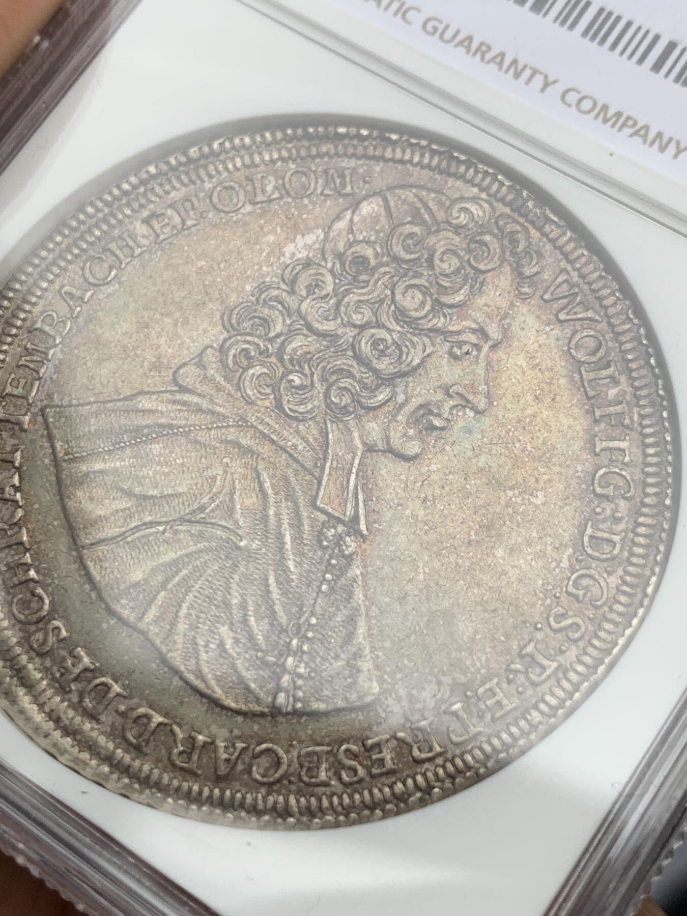 《竞宝斋》第373场 周日，周一，周二 3场连拍 （全场包邮） NGC UNC 神圣罗马帝国波西米亚王国奥尔穆茨主教区1716年泰勒大银币 币面打制清晰，高点具在，黑五彩包浆，单一年份  这个头像还是首见