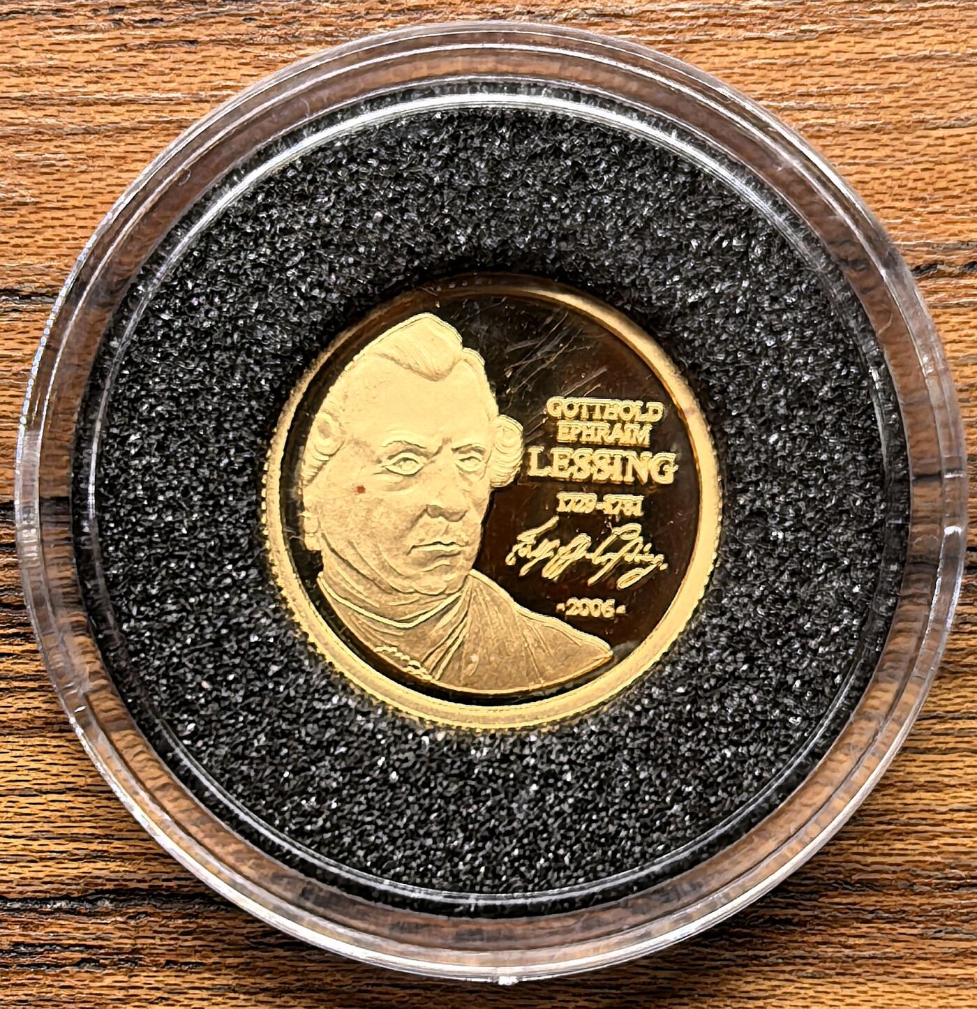 凡希社世界钱币微拍第三百零三期 2006多哥莱辛纪念1500法郎小金币全品，1.24g，999金。