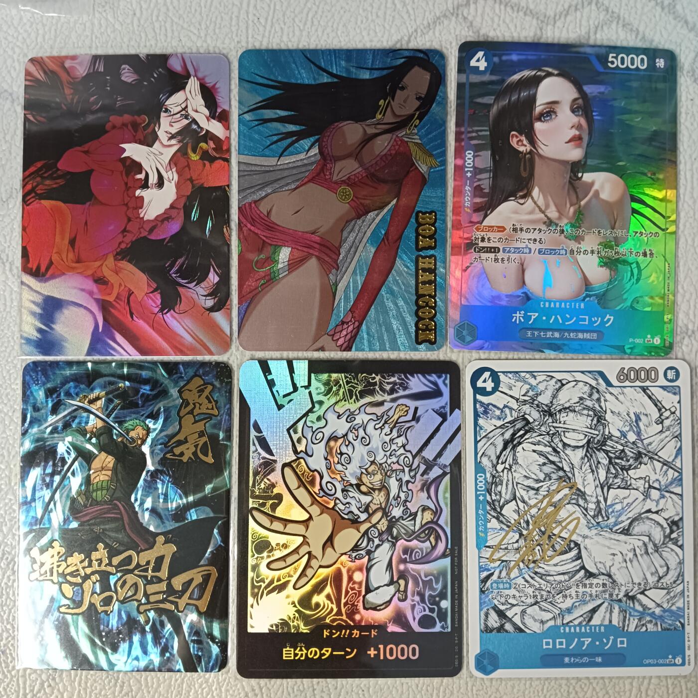 花开卡拍第29期（品控勿拍!!!拍品不寄存，运费5元，自制卡难免瑕疵，可能存在轻微撞角爆边等出厂瑕疵，品控介意勿拍！） 江东卡牌 海贼王6张 小银包 包括女帝粗闪+彩闪+折光彩闪 