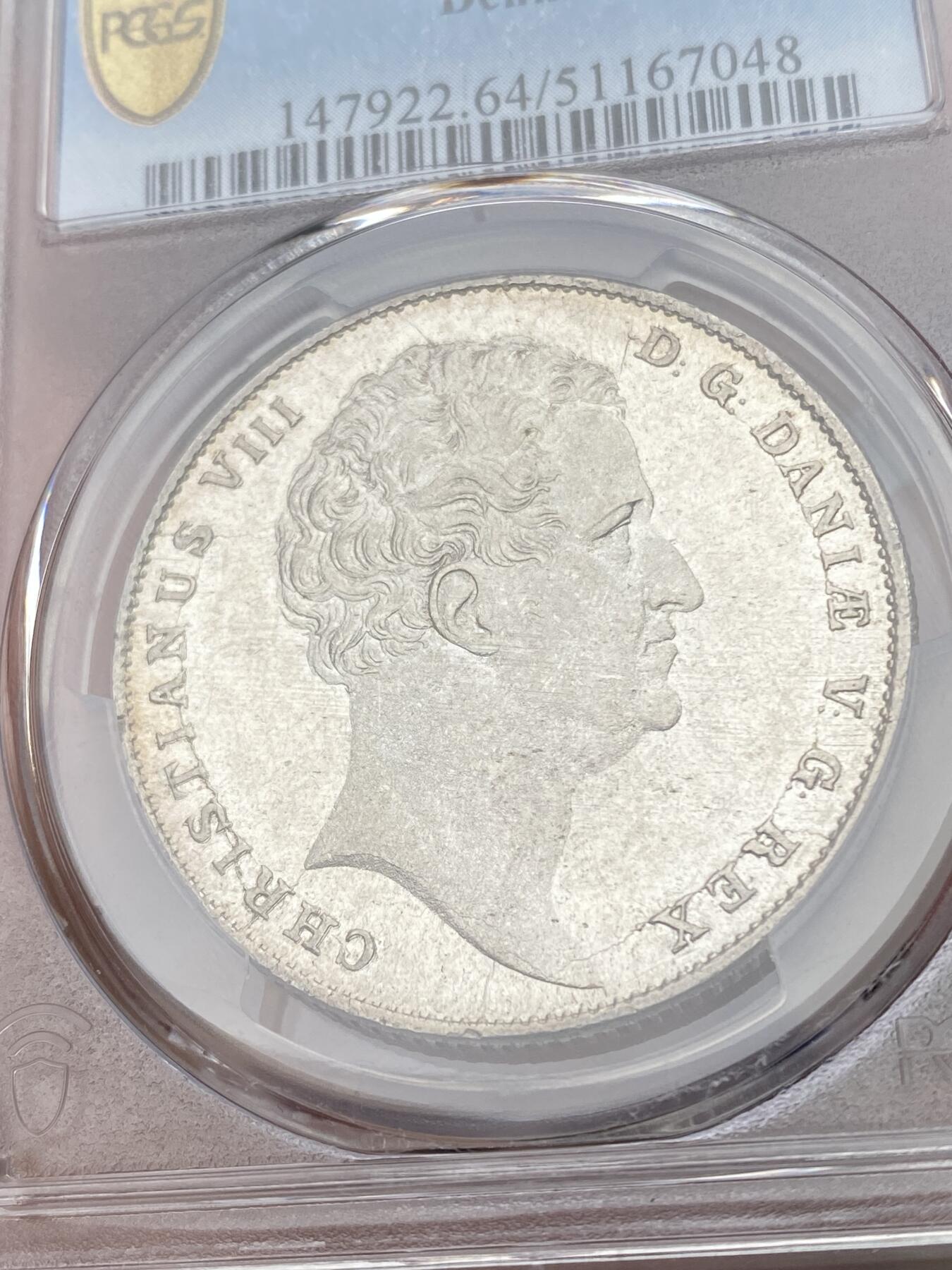 万国钱币拍卖第049期（万国夏季大拍） PCGS MS64 1847丹麦克里斯蒂安八世野人护盾达勒 设计非常出彩的一款北欧大银 野人纹章兼具了观赏性和趣味性 人像喷砂底板类镜面质感 PC唯一冠军。