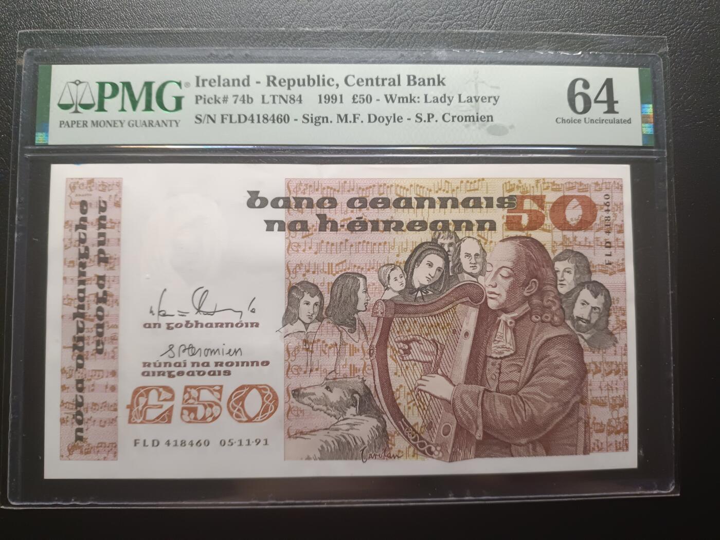 2025七月第一期（总第183期） 爱尔兰1991年50镑PMG64分，主题肖像是16世纪的盲人竖琴演奏家奥卡罗兰和周围聆听的人群，作为爱尔兰象征之一的竖琴也当之无愧的登上了此版本最大面值的钞票上