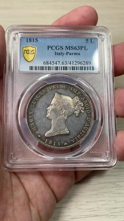 万国钱币拍卖第049期（万国夏季大拍） PCGS MS63PL 1815意大利帕尔马5里拉银币 正面帕尔马女大公是拿皇的妻子玛丽亚·路易斯，背面帕尔马纹章繁复华丽，好品极其难得的意系大银，国际市场广受欢迎品种，获得PL评分的更是凤毛麟角，均匀一色的玫瑰彩包浆搭配类镜面质感的底板，典藏级品质。