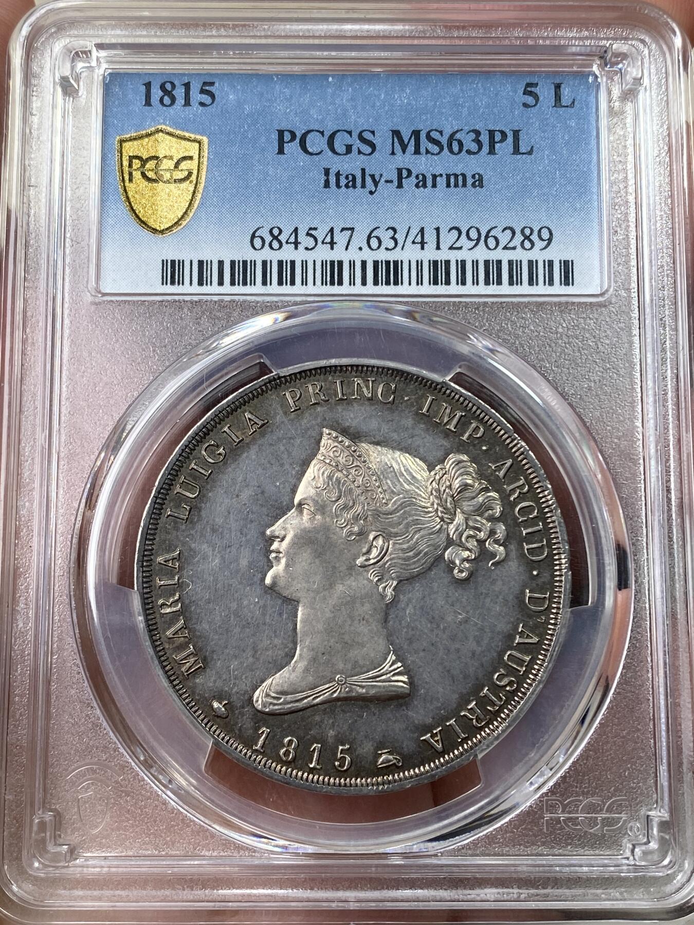 万国钱币拍卖第049期（万国夏季大拍） PCGS MS63PL 1815意大利帕尔马5里拉银币 正面帕尔马女大公是拿皇的妻子玛丽亚·路易斯，背面帕尔马纹章繁复华丽，好品极其难得的意系大银，国际市场广受欢迎品种，获得PL评分的更是凤毛麟角，均匀一色的玫瑰彩包浆搭配类镜面质感的底板，典藏级品质。