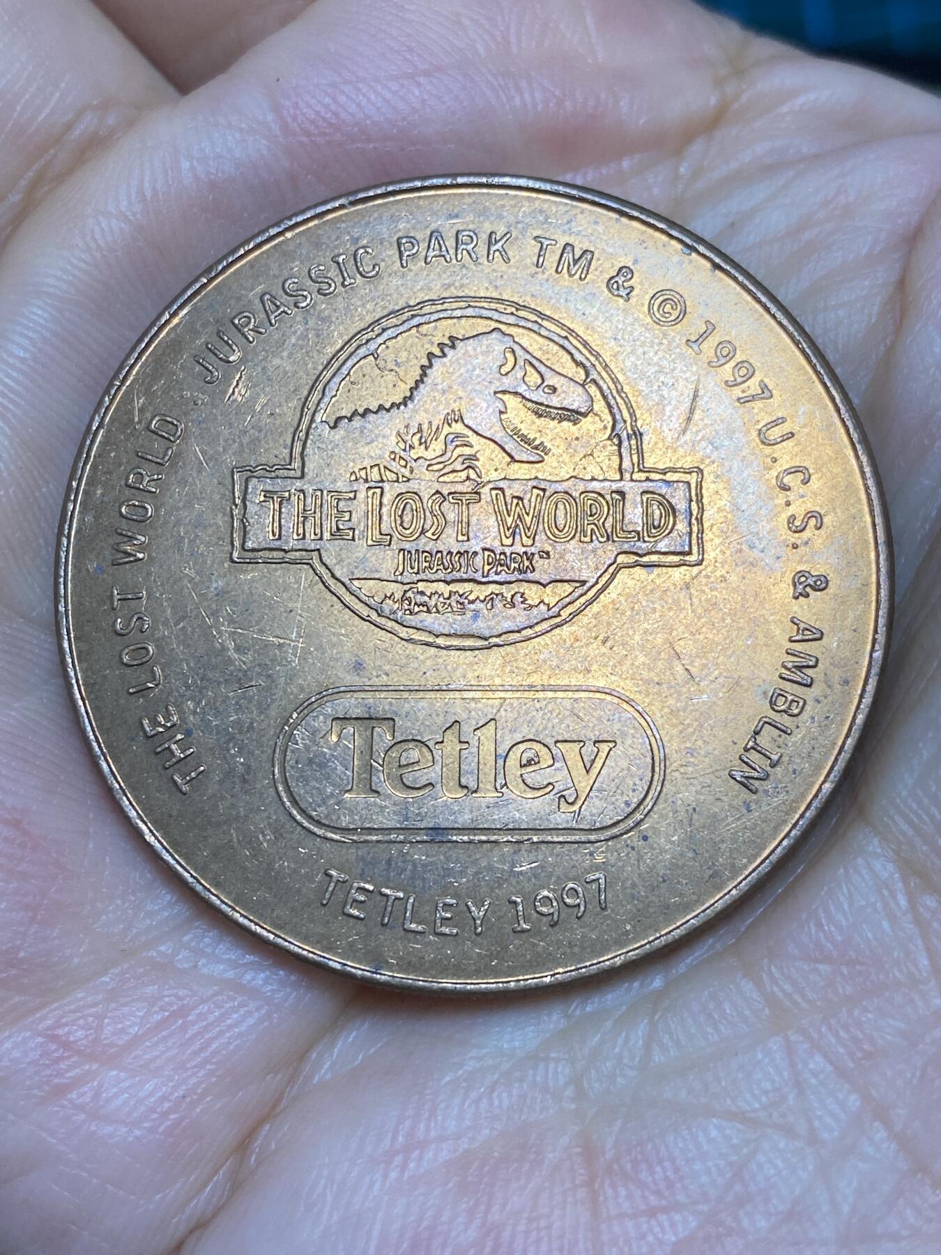2025年第六十四场(总第九十场）外国好品散币(免佣金) 英国🇬🇧Tetley茶叶公司联名电影“侏罗纪公园2:失落的世界”纪念大铜章(迅猛龙图案)