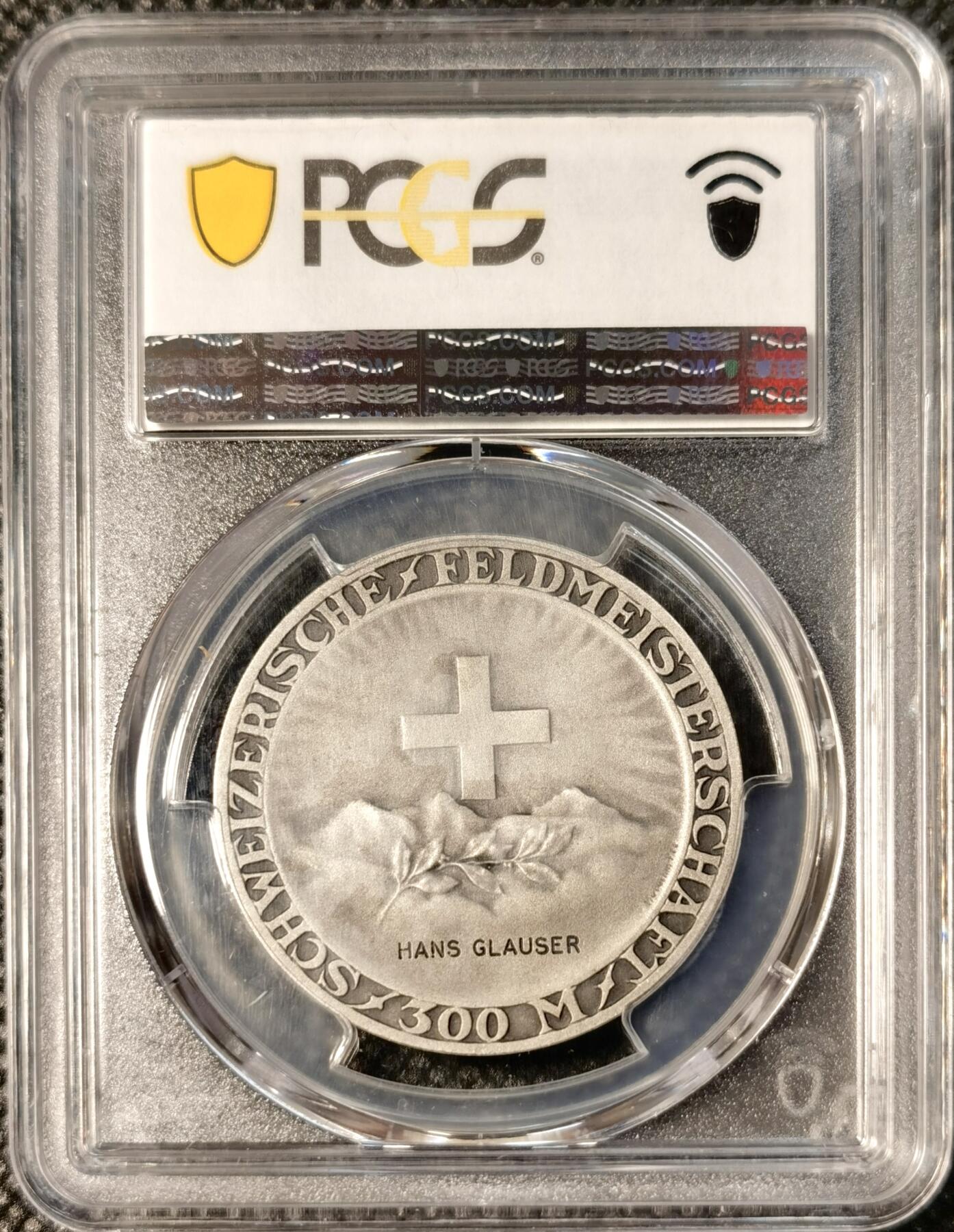  甄臻铺-世界币章拍卖（第25期），送拍享返佣金等优惠多多 PCGS-SP65 瑞士射击节获奖银章，参考手册R-1973a(PCGS错评成R-1975A)。正面是瑞士联邦标志和山景图案，背面是女性头像，由Hans Glauser获奖，直径35毫米