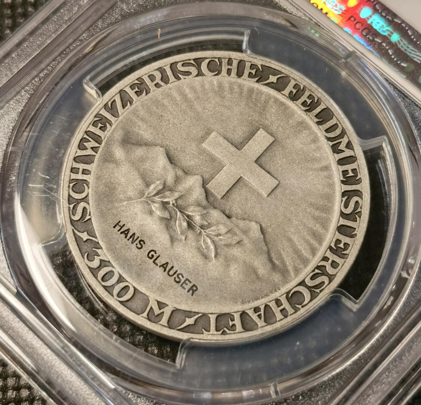  甄臻铺-世界币章拍卖（第25期），送拍享返佣金等优惠多多 PCGS-SP65 瑞士射击节获奖银章，参考手册R-1973a(PCGS错评成R-1975A)。正面是瑞士联邦标志和山景图案，背面是女性头像，由Hans Glauser获奖，直径35毫米