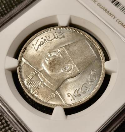 甄臻铺-世界币章拍卖（第28期），送拍享返佣金等优惠多多 NGC-MS64 1939年埃及法鲁克国王10皮阿斯特银币，正面刻有法鲁克国王头像，背面阿拉伯文和花卉装饰，品相完好，包浆自然，更高分只有8枚