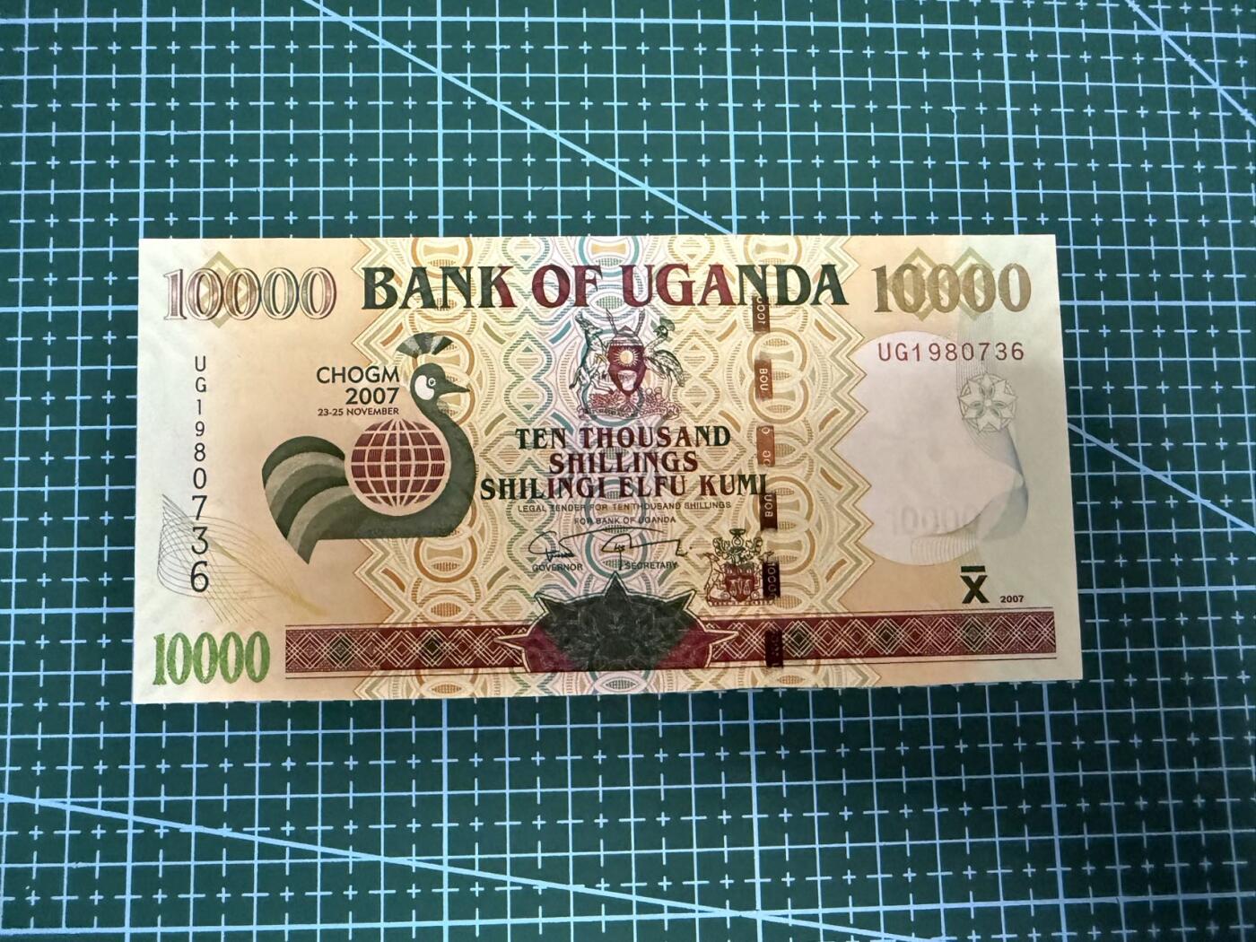 【炜奕收藏】，第四十一期 2007年乌干达10000先令纪念钞，UNC-品相，水印处有车轮印