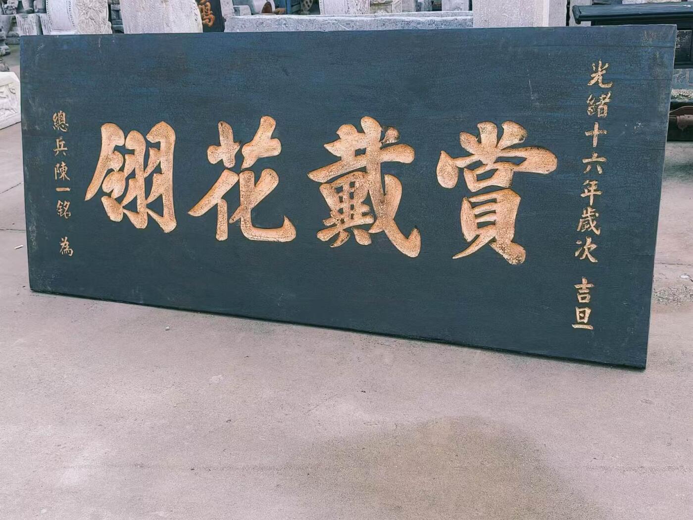 赏戴花翎是清代皇帝授予有功之臣或特殊贡献者的荣誉性冠饰，以孔雀翎制成，分单眼、双眼、三眼三个等级，象征身份与功勋。 乡下拆迁淘得，大清光绪十六年，皇上钦赐给总兵，陈一铭的，大号柏木老官匾，赏戴花翎一块。阴工描金字，材质好，个头够大。品相完整牢固，值得收藏和拥有。 尺寸长宽厚214/91/5cm。