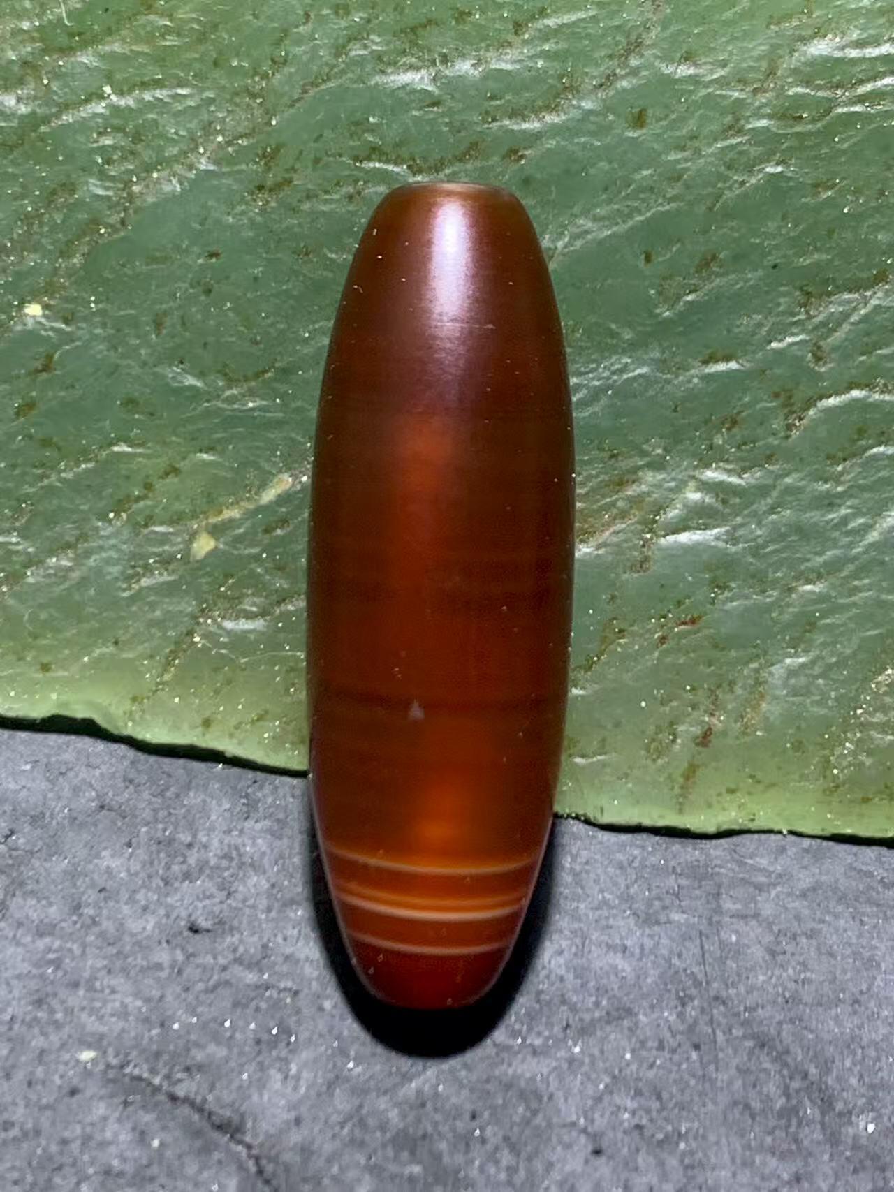 精美高玉化酒红色玛瑙随形通货桶珠一颗