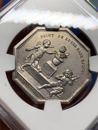 《竞宝斋》第410场 周日，周一，2场连拍 （全场包邮） NGC MS64 高分  苦与乐，婚姻系列中最精彩一枚，正面图案为苦与乐双面神，背面责任一对爱情的小天使，一个正在摘取带刺的玫瑰（玫瑰代表婚姻与爱情），一个被被玫瑰刺扎伤正在哭泣，像极了爱情的苦与乐