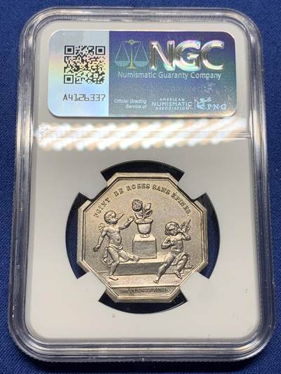 《竞宝斋》第410场 周日，周一，2场连拍 （全场包邮） NGC MS64 高分  苦与乐，婚姻系列中最精彩一枚，正面图案为苦与乐双面神，背面责任一对爱情的小天使，一个正在摘取带刺的玫瑰（玫瑰代表婚姻与爱情），一个被被玫瑰刺扎伤正在哭泣，像极了爱情的苦与乐