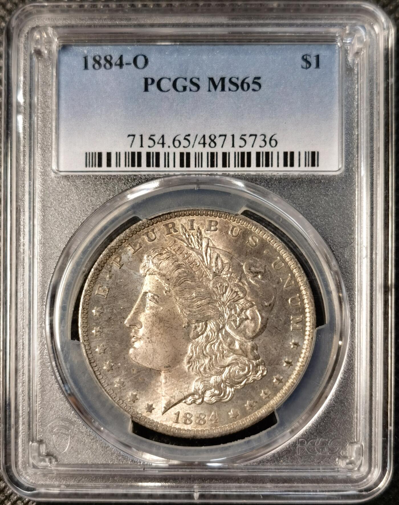 甄臻铺-世界币章拍卖（第30期），送拍享返佣金等优惠多多 PCGS-MS65 1884年O版摩根，正面紫金色包浆，状态极佳，阴阳脸卷首
