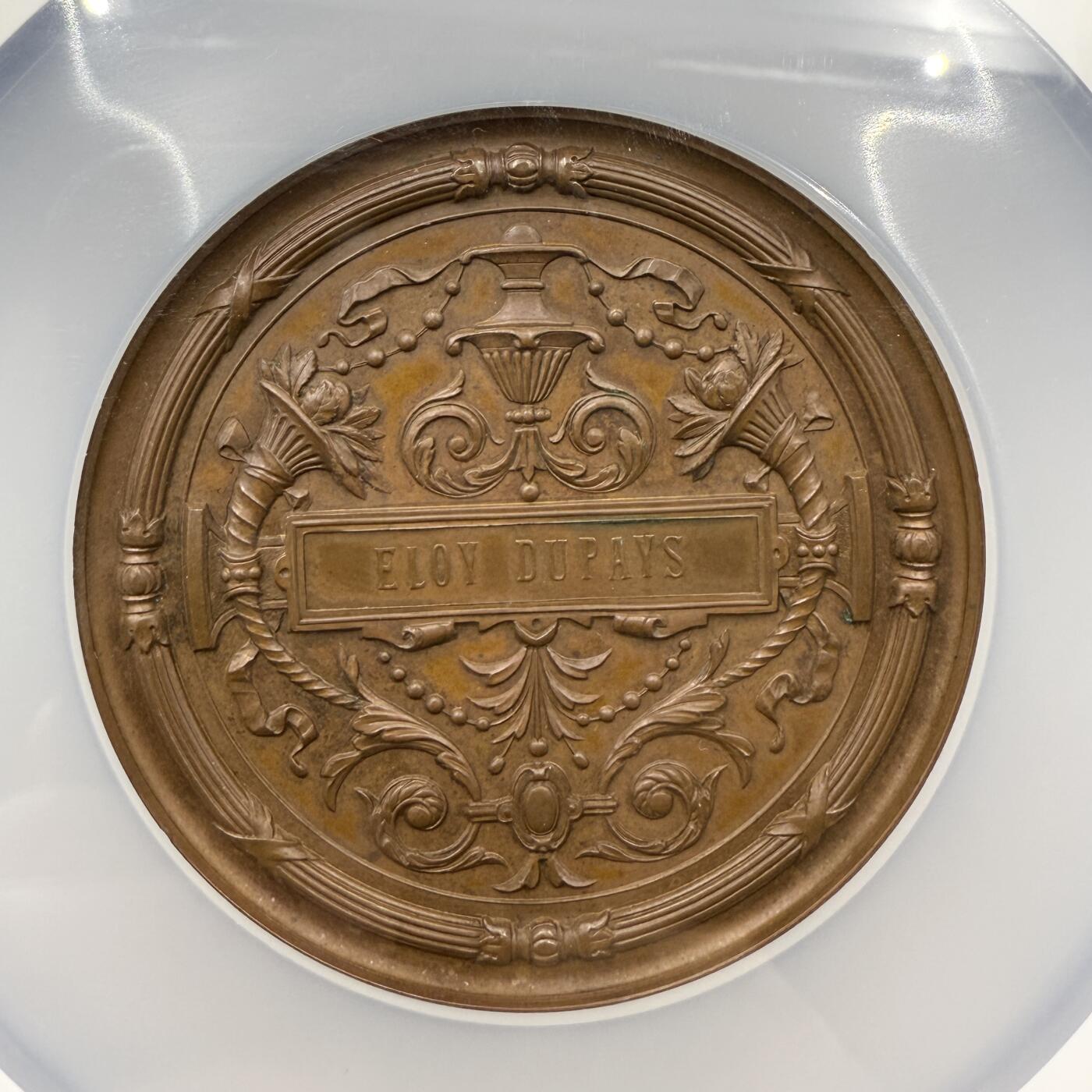 「木头集藏」章牌精品专场！ Anton Scharff ～1881年德国法兰克福专利与设计保护展览会大铜章，MS 64 ，直径：63mm，沙夫代表作品，正面中央刻画带翅膀的女性形象（象征着创意、守护或胜利），姿态舒展，周围有两个小天使形象，一个手持工具（似代表发明、创造），另一个手持书卷（似代表知识、专利文献等），整体营造出对发明创造、专利保护的歌颂与推崇氛围，品相很不错！