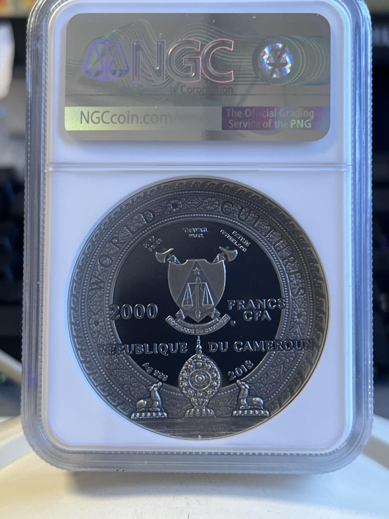 第172期拍卖【长期征集拍品】 喀麦隆2018世界文化系列1卡帕头骨2盎司高浮雕镶嵌银币NGC-PF69原盒证书，999银，发行500枚