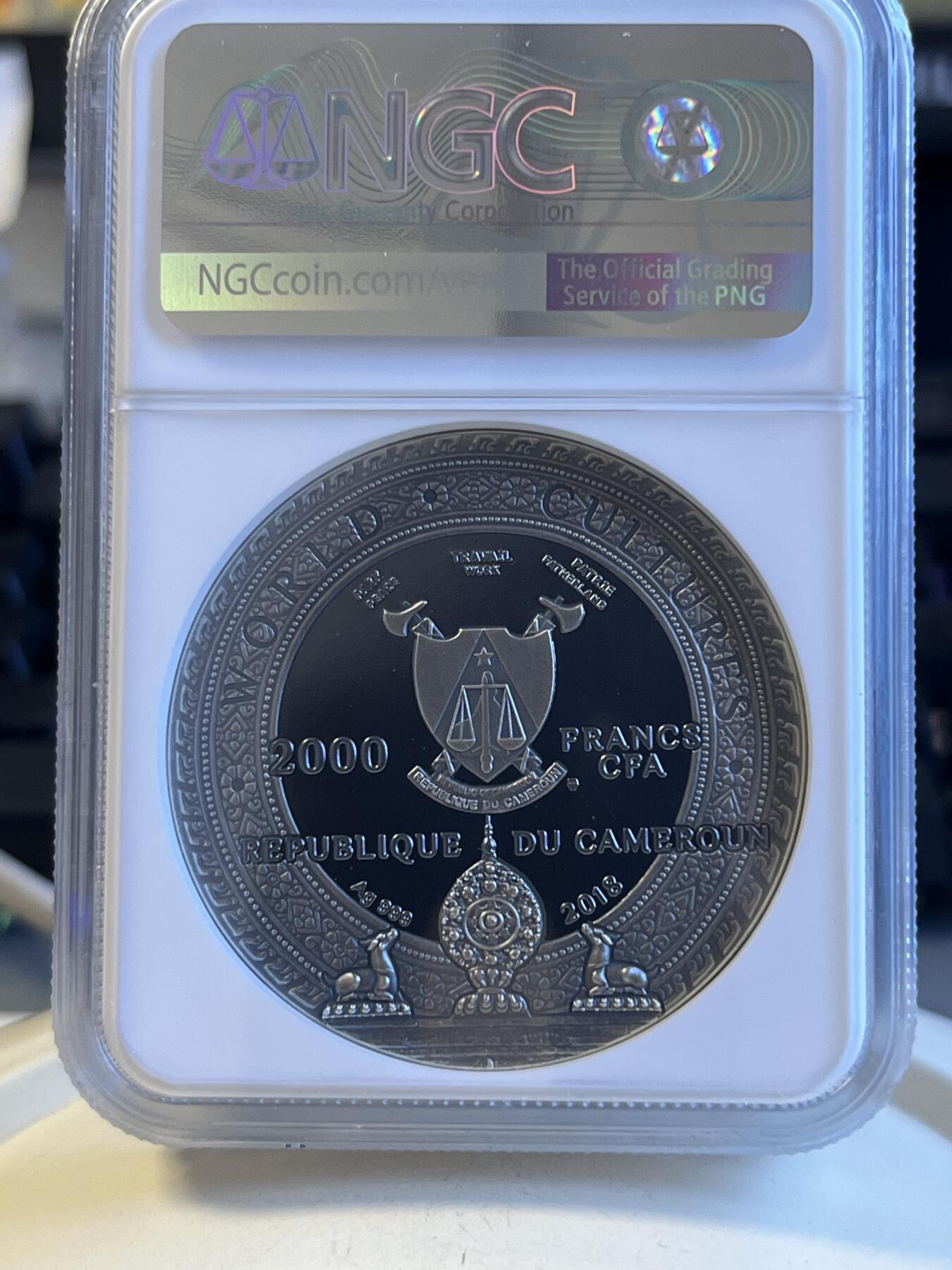第172期拍卖【长期征集拍品】 喀麦隆2018世界文化系列1卡帕头骨2盎司高浮雕镶嵌银币NGC-PF69原盒证书，999银，发行500枚