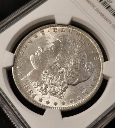甄臻铺-世界币章拍卖（第34期），送拍享返佣金等优惠多多 NGC-MS62 美国1884年O版摩根银元 带一点淡淡的包浆 底板不错 个人送评 上海N有点压分了 状态很不错