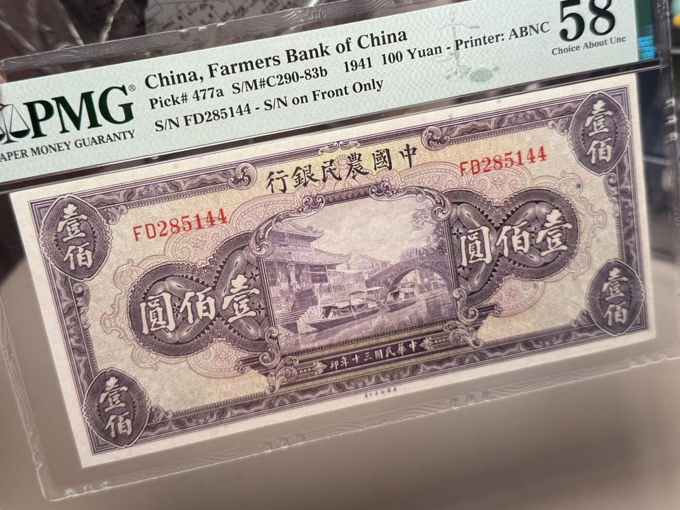 （自动截拍）PMG评级民国纸币专拍第20251001期，全场包邮 【乾奕收藏】出民国30年1941年中国农民银行美钞版壹佰圆一枚，正面浙江海宁紫薇桥图案，美国PMG58分