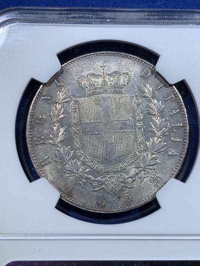 《竞宝斋》第423场 周日，周一，周二  3场连拍 （全场包邮） NGC MS63 意大利1875M流通5里拉大银币，埃曼努尔二世，米兰厂。淡金彩浆，转光流畅，更高分仅4枚，意系流通主币中难得比较低估的品种。同年64+麦稀奇5201元不含佣成交