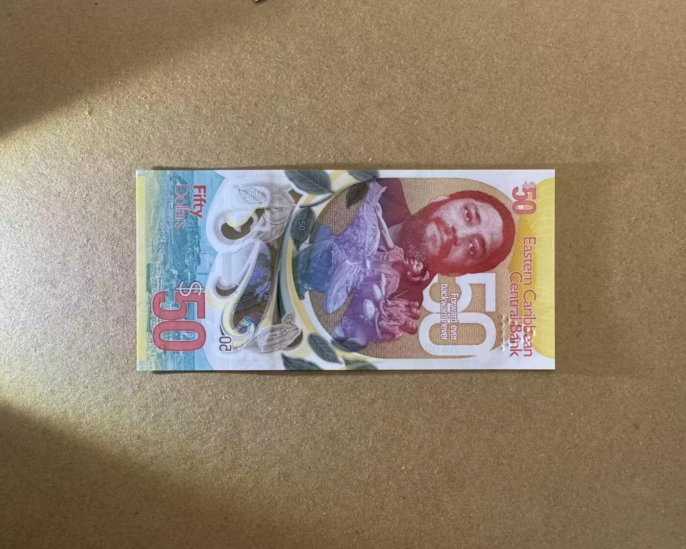 【Blue Auction】世界纸币精拍第733期——祝各位藏友国庆中秋假期快乐！ 【AA冠无47千位小号】东加勒比 新版50元 全新UNC