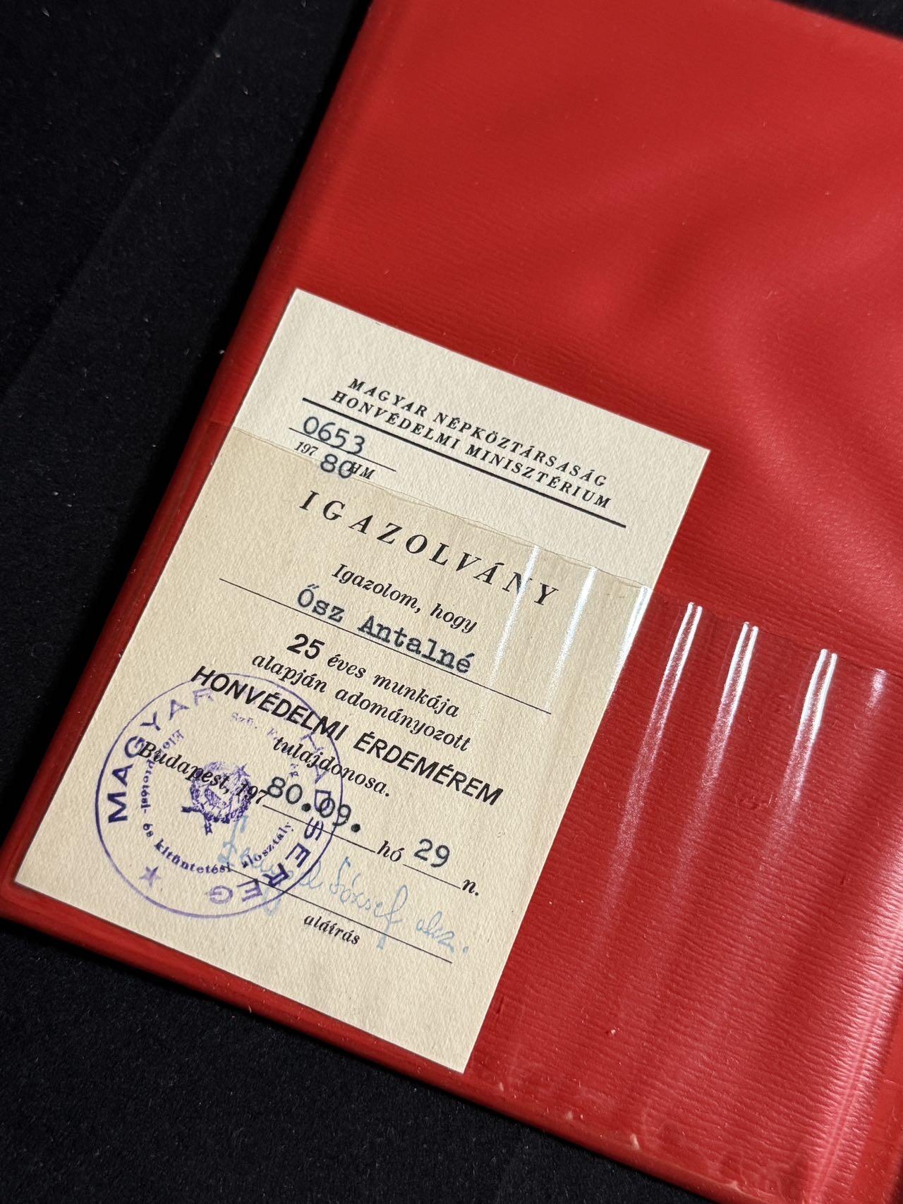 双节同庆！铭记历史！以史为鉴！戎马世界章牌大赏第106期 匈牙利国防功勋奖章证书，授予 Ősz Antalné 女士，以表彰其在国防系统中连续25年的杰出工作，日期为1980年9月29日。证书配有原始红色封套及官方小型证明卡（Igazolvány），并带有国防部长签名与官方印章