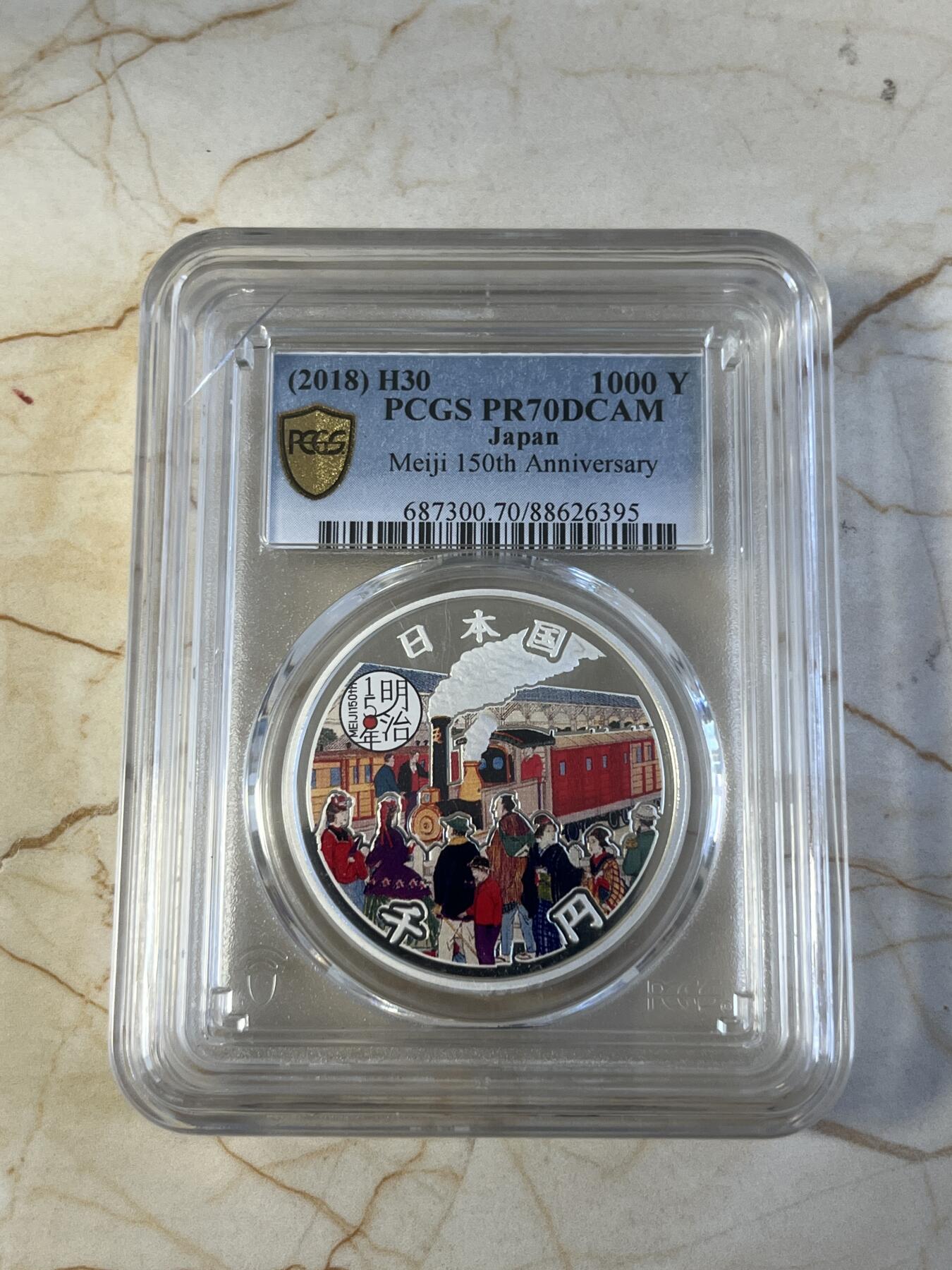 第177期拍卖【长期征集拍品】 PCGS PR70DCAM 2018年发行的日本明治150周年彩银纪念币-1000日元（1盎司克重，999纯银，币径40MM，限量发行5万枚）